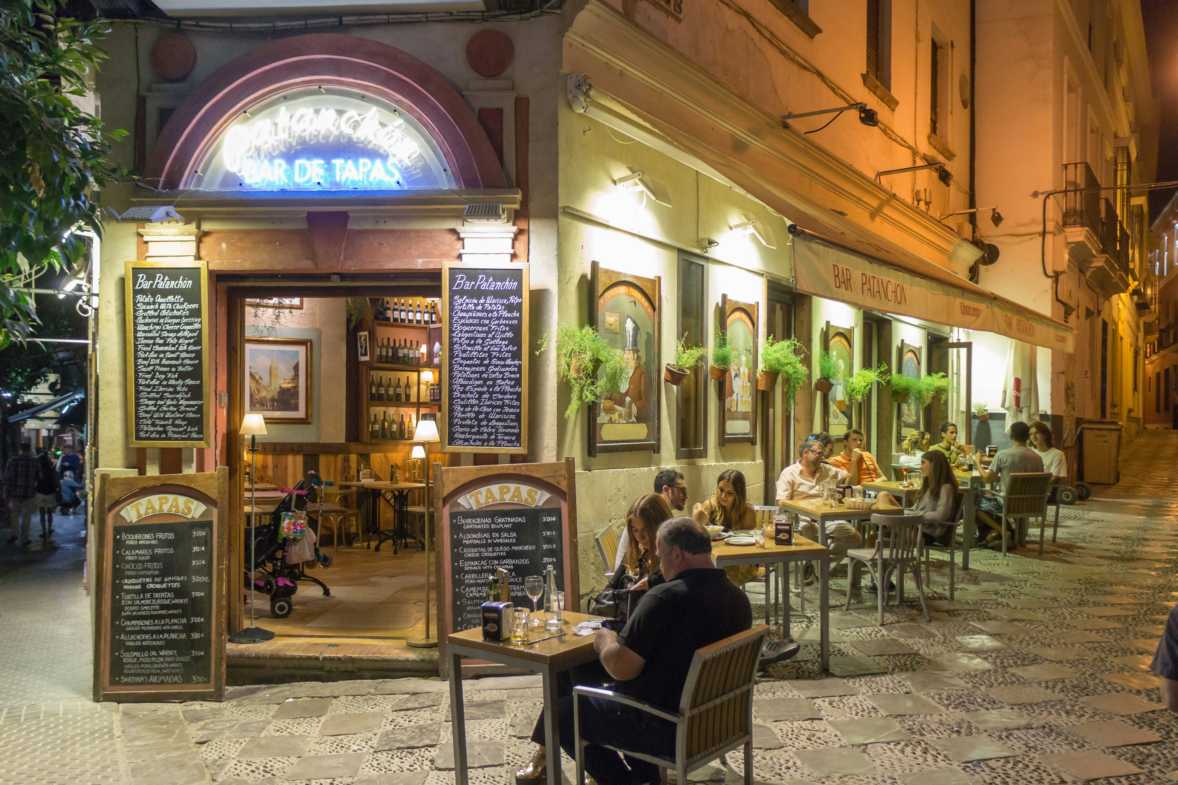 People sitting outside during summer in old Seville