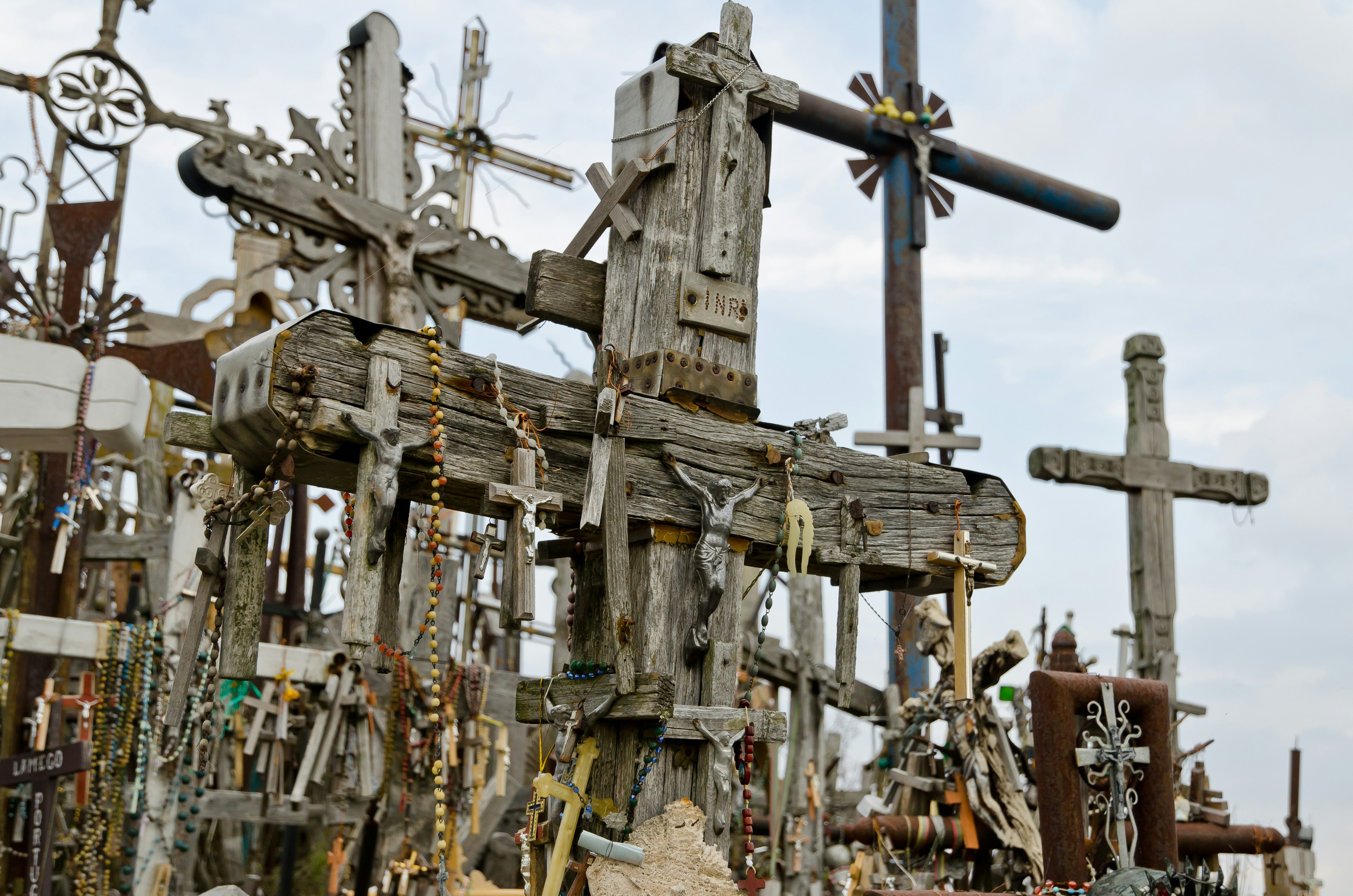 Multiple crosses of different sizes on the Hill of Crosses in Lithuania