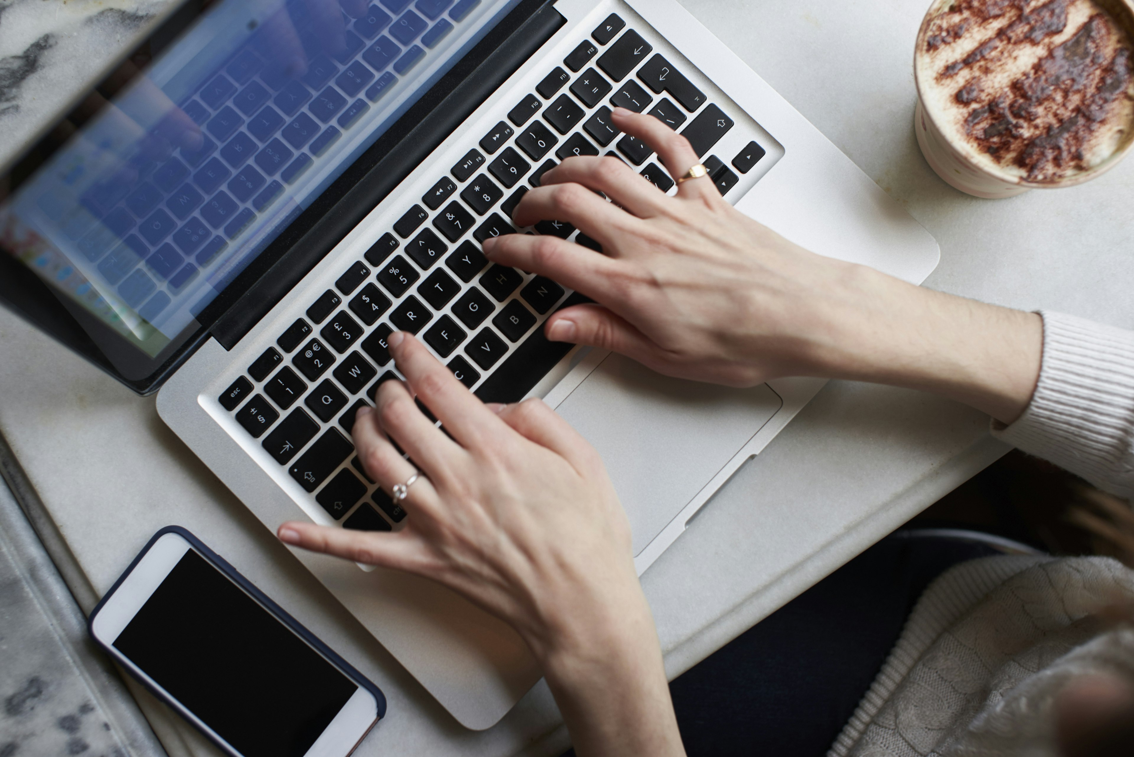 Overhead View Of Young Woman Using a laptop