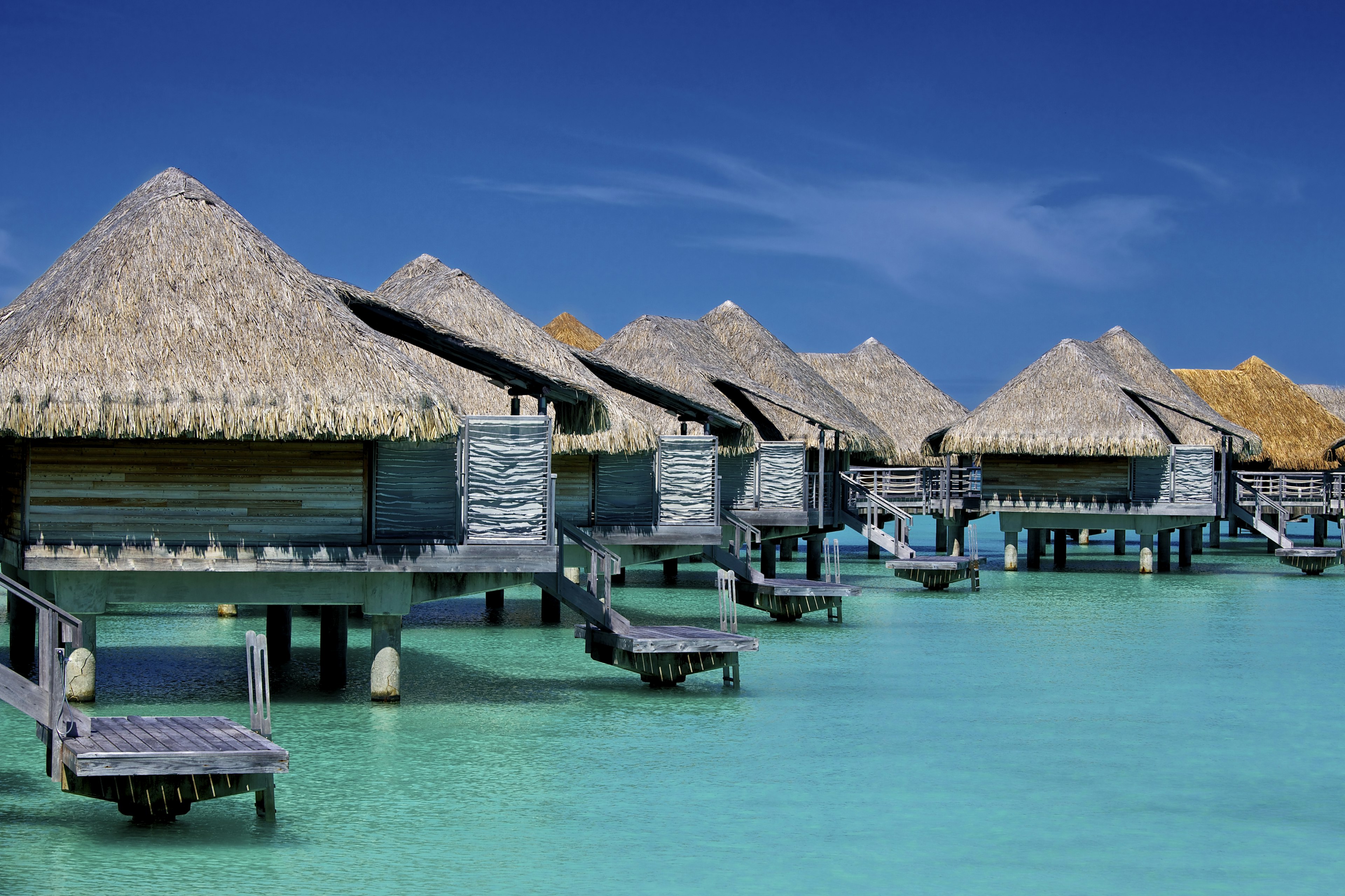 Overwater bungalows over blue waters, Bora Bora