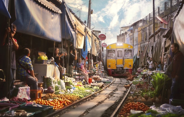 The Bangkok train arriving at the Samut Sakhon Railway Market