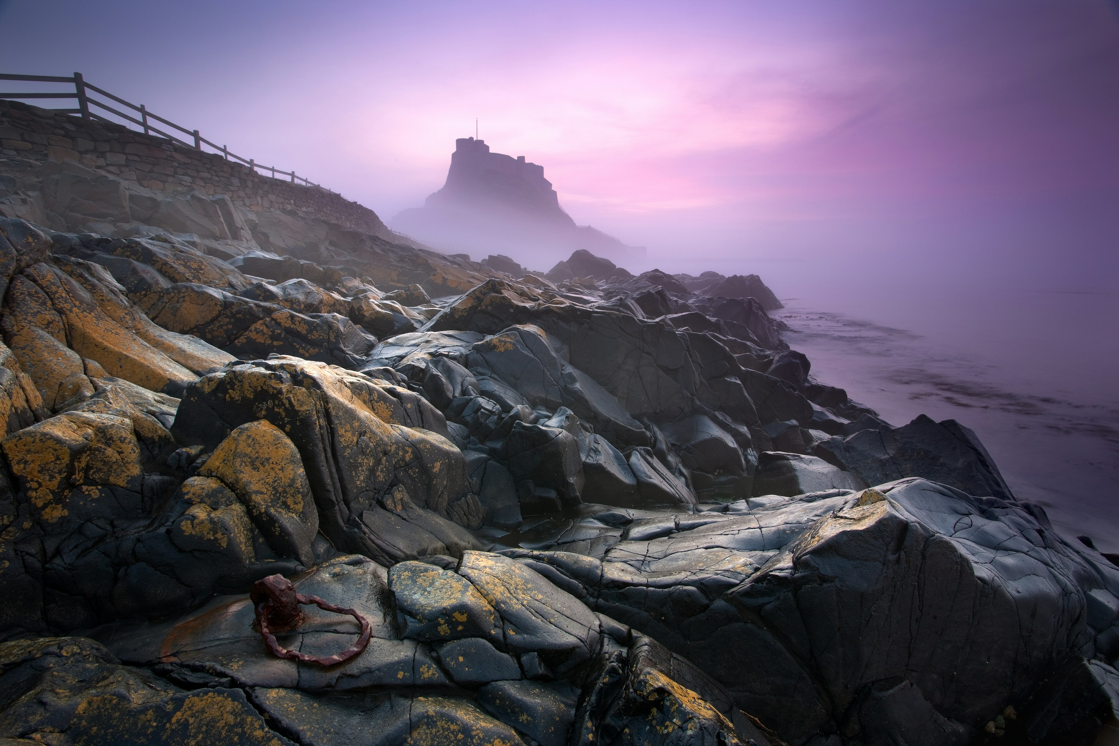 Lindisfarne Castle with dawn sea mist.