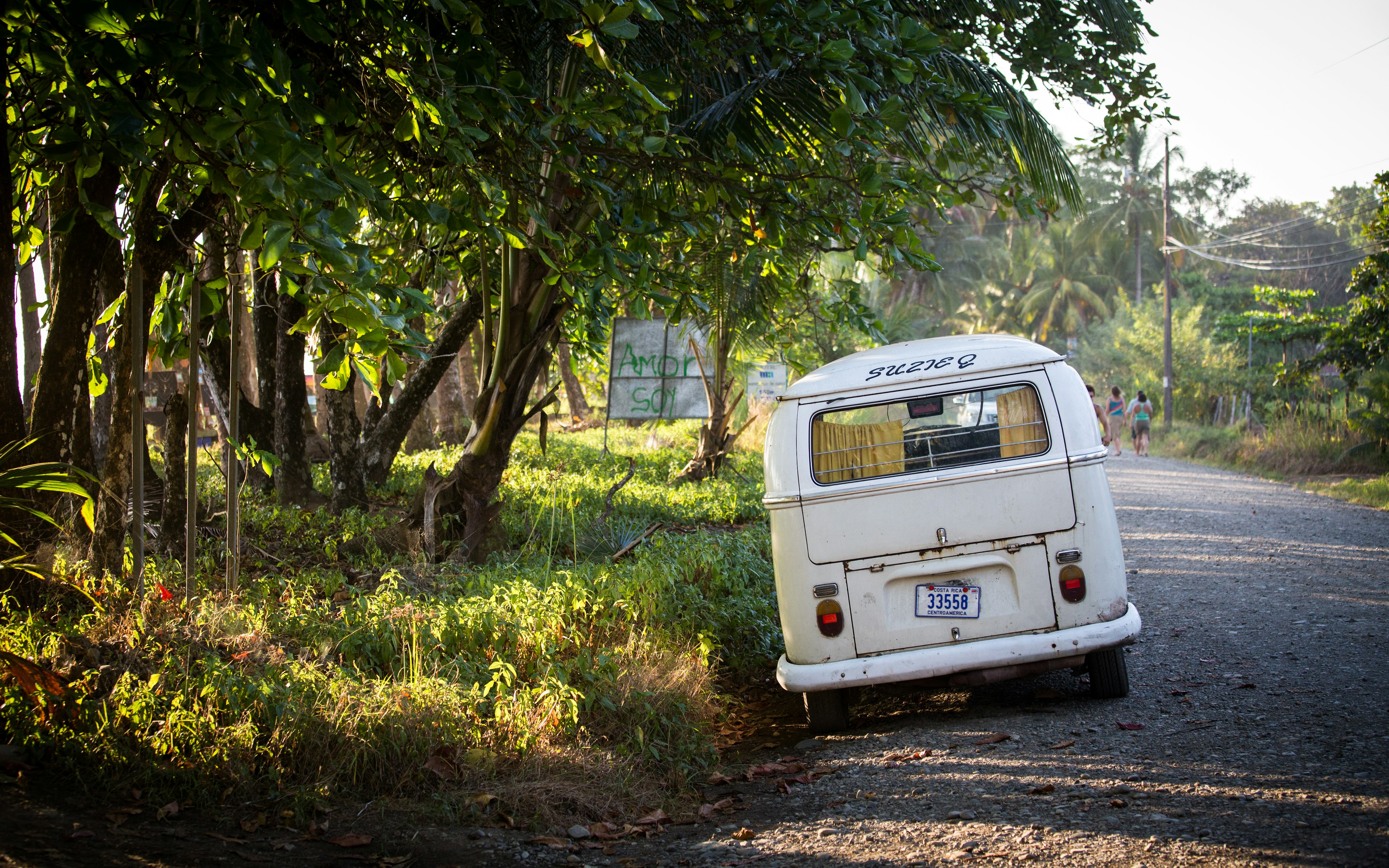 A small campervan parked at the side of a road