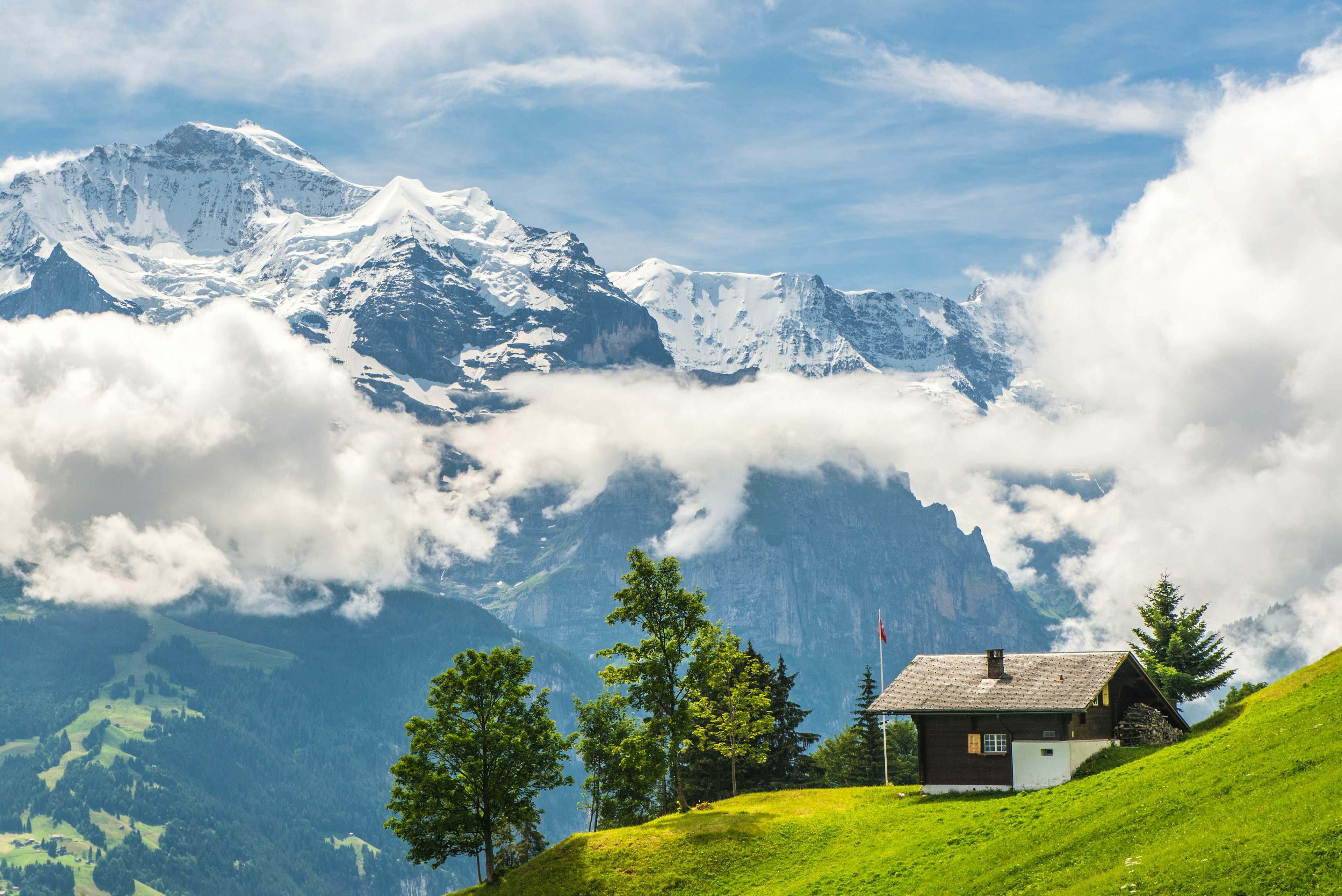 Swiss view on the Jungfrau with Swiss chalet and flag