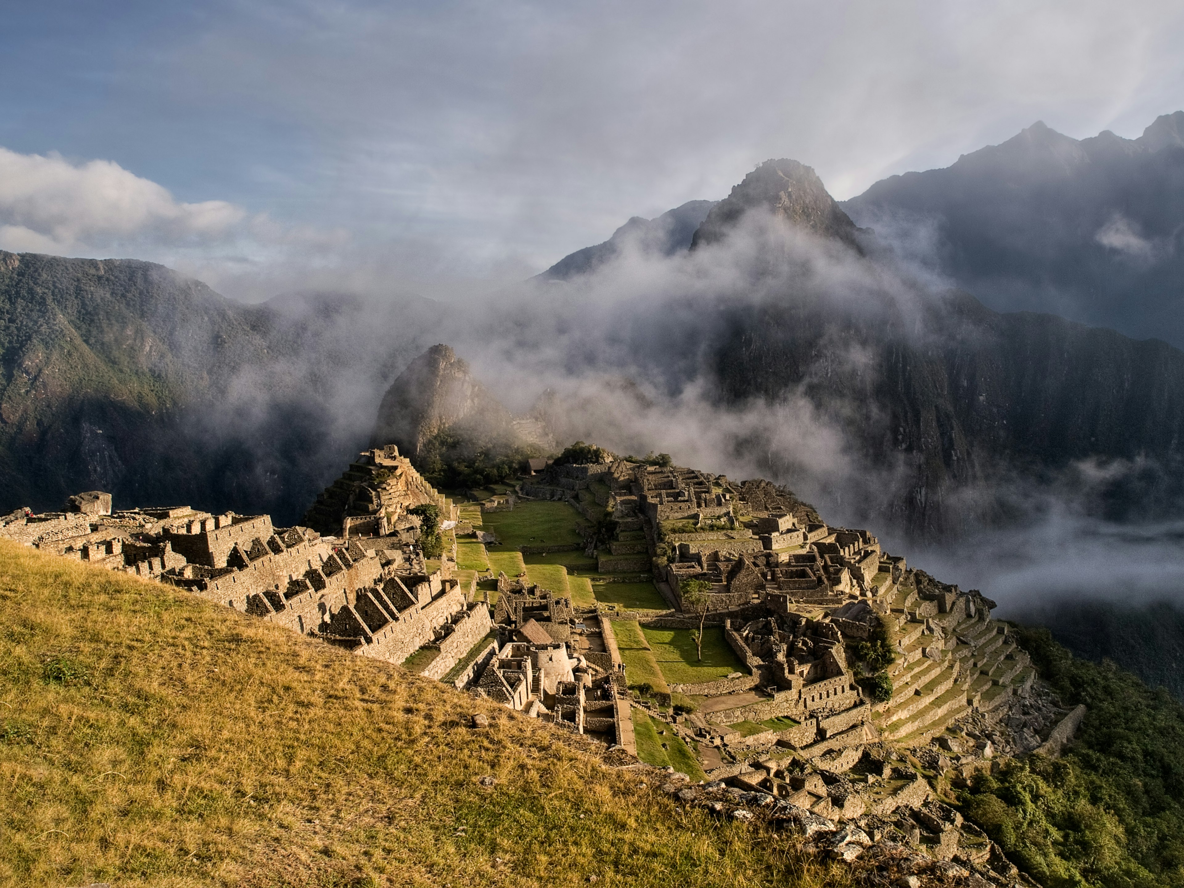 Machu Picchu is cloaked in fog.