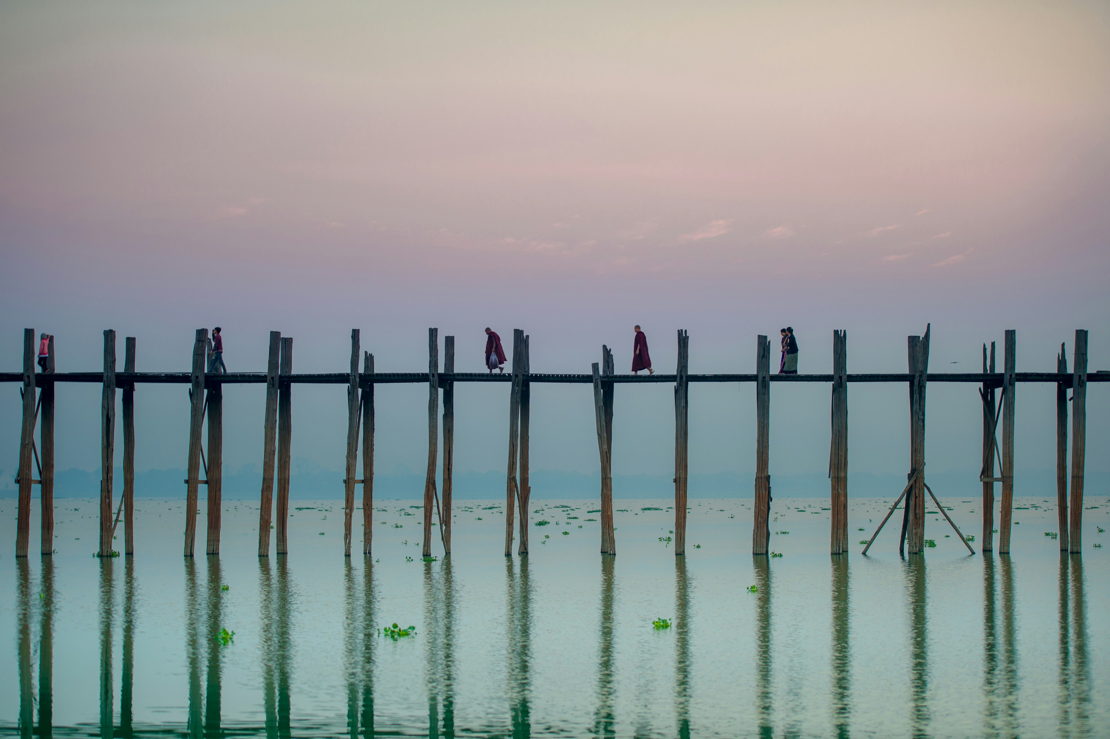 People cross U-Bein bridge in  Myanmar, Mandalay.