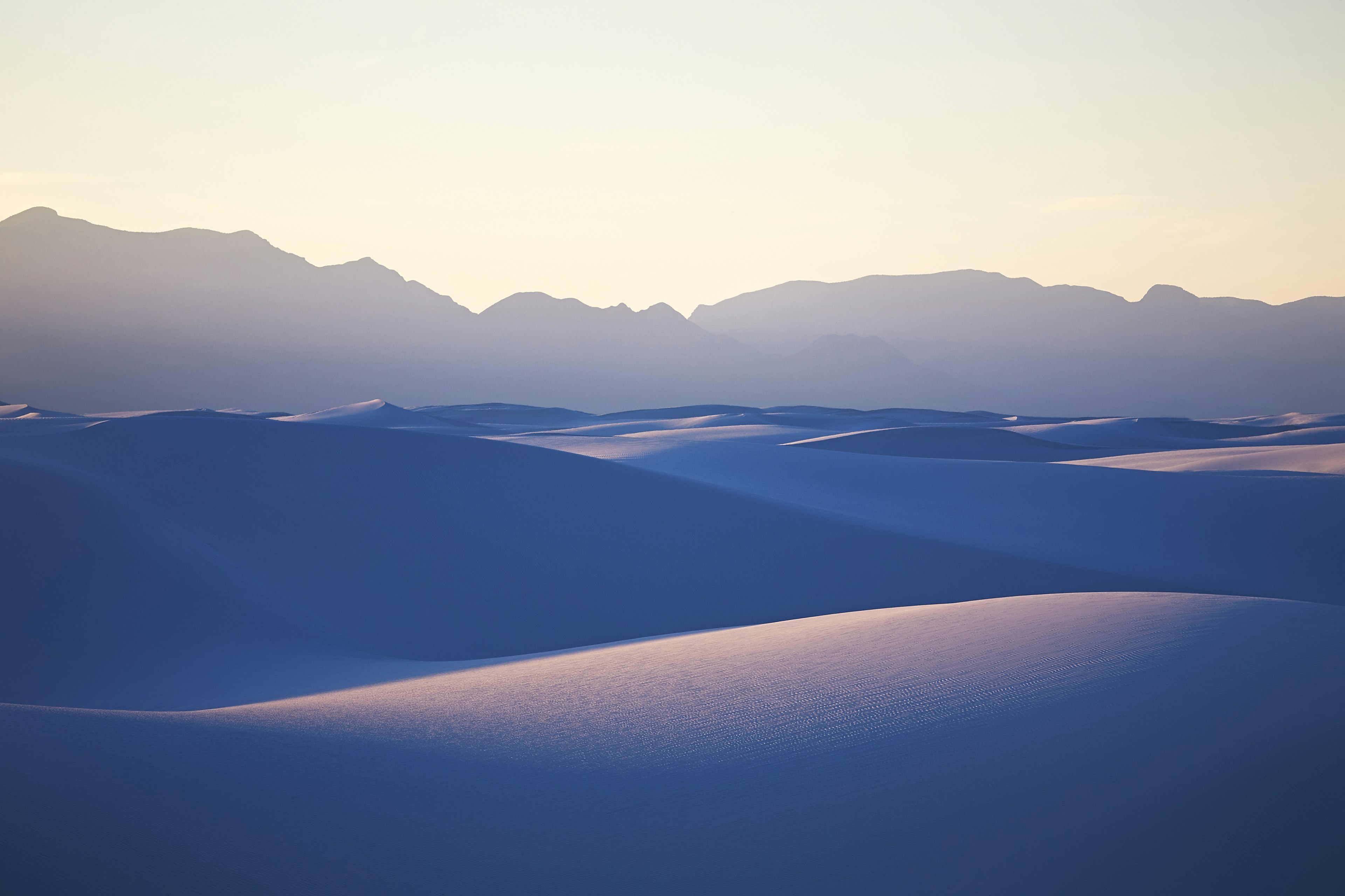 White sands rolling under a blue light