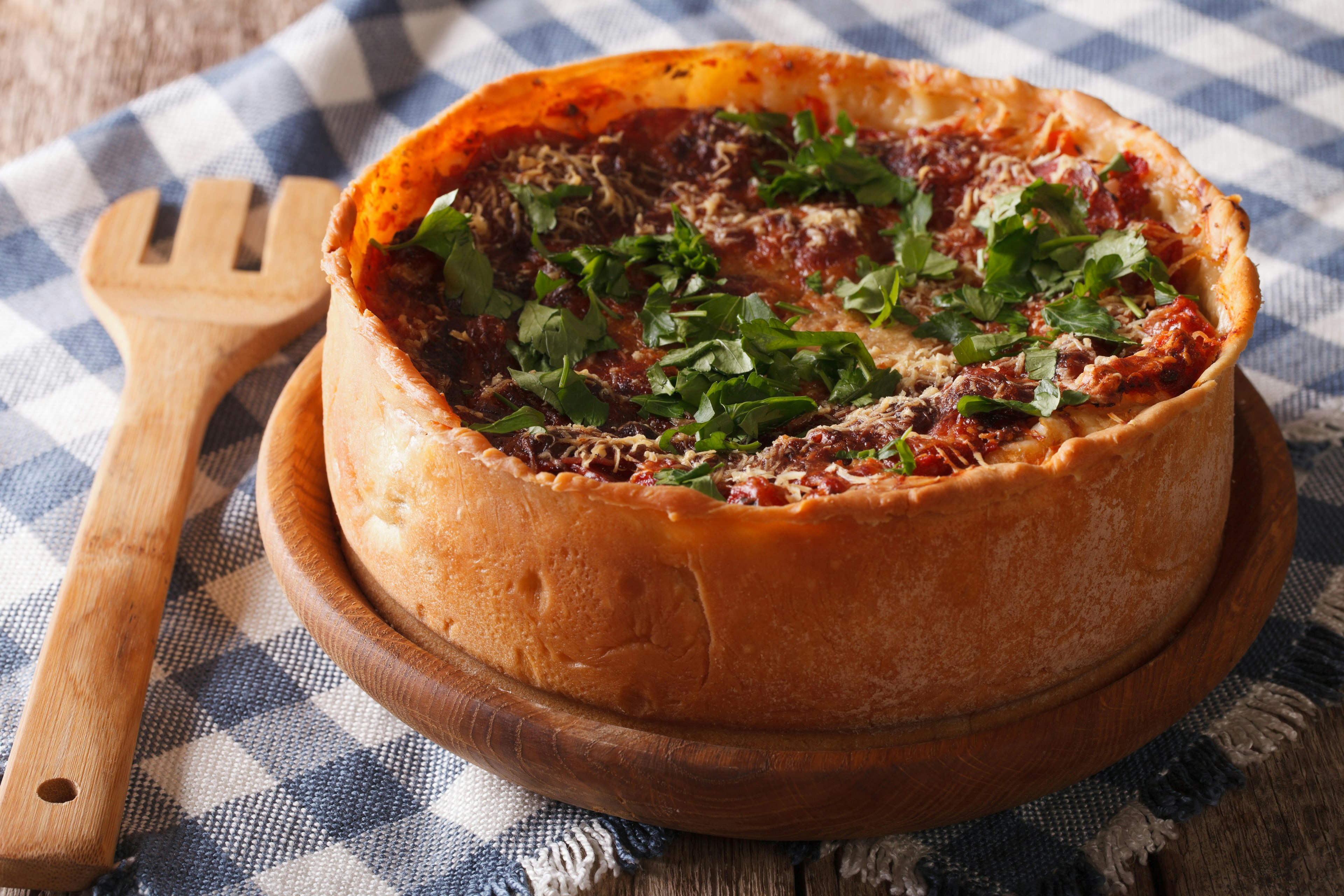 Rustic of Chicago deep dish pizza close-up on the table. horizontal