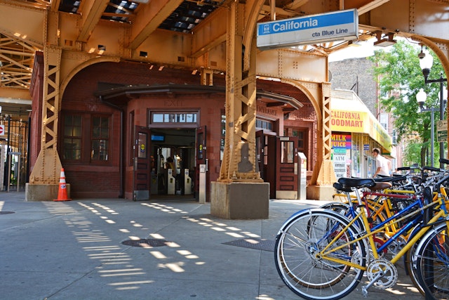 Commuter bicycles parked outside the entrance to the California L Train Station on Chicago's Blue Line in the Logan Square neighborhood
