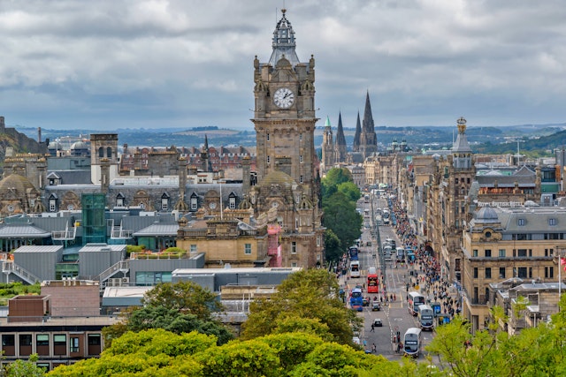 A busy city street lined with double-decker buses and other traffic