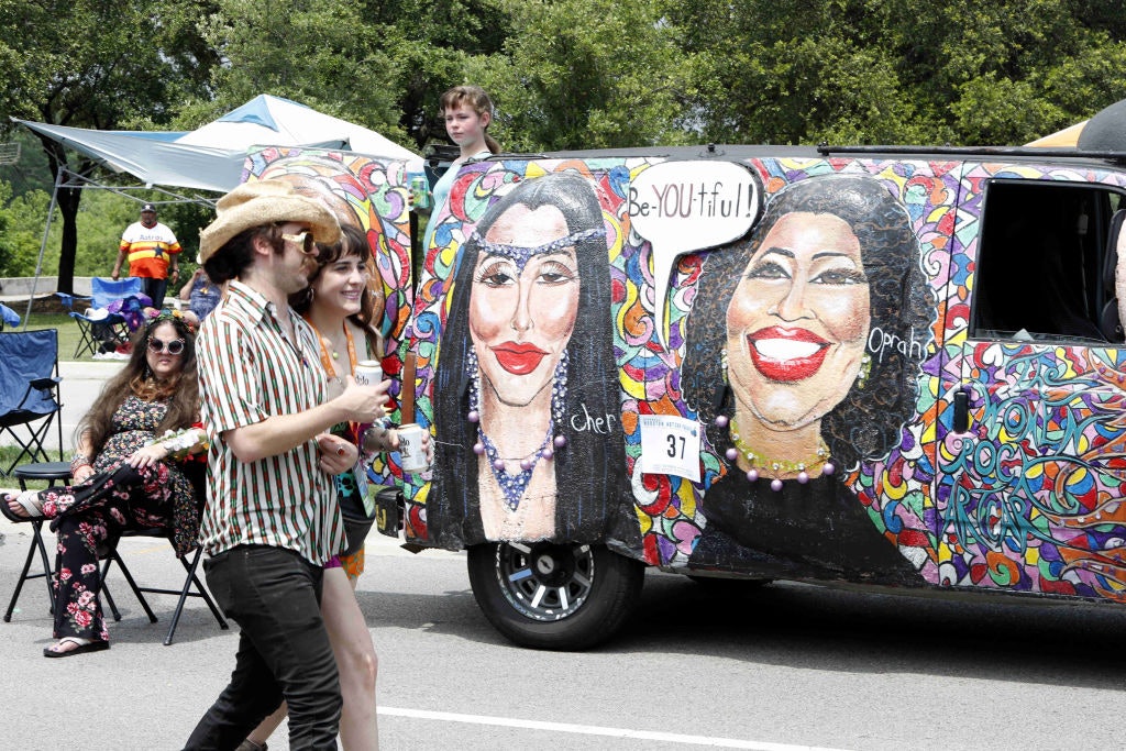 People pass by the mobile masterpiece in Houston, Texas, the United States on April 13, 2019. The 32nd Annual Houston Art Car Parade is the world's oldest and largest Art Car Parade.