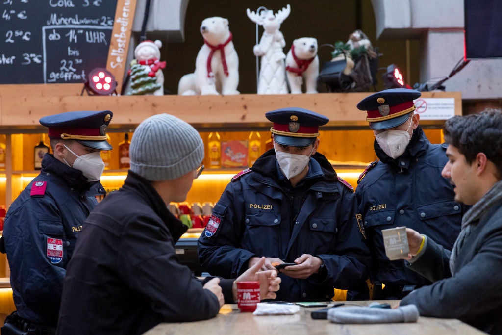 Police officers monitor compliance with the lockdown in Innsbruck's old town during the first day of a nationwide lockdown