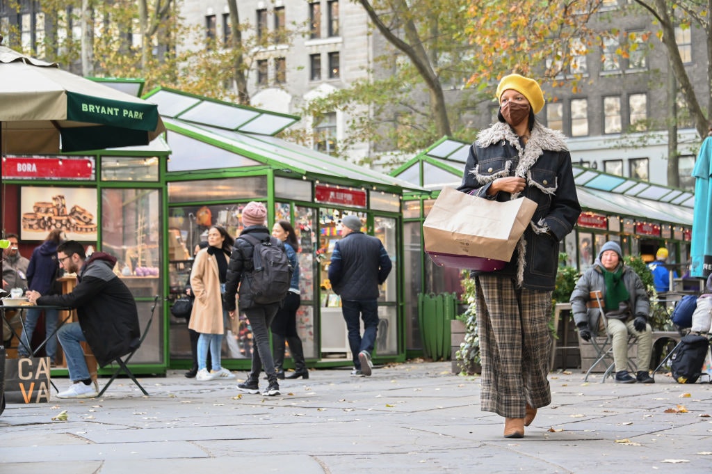 People are seen at Bank of America Winter Village at Bryant Park