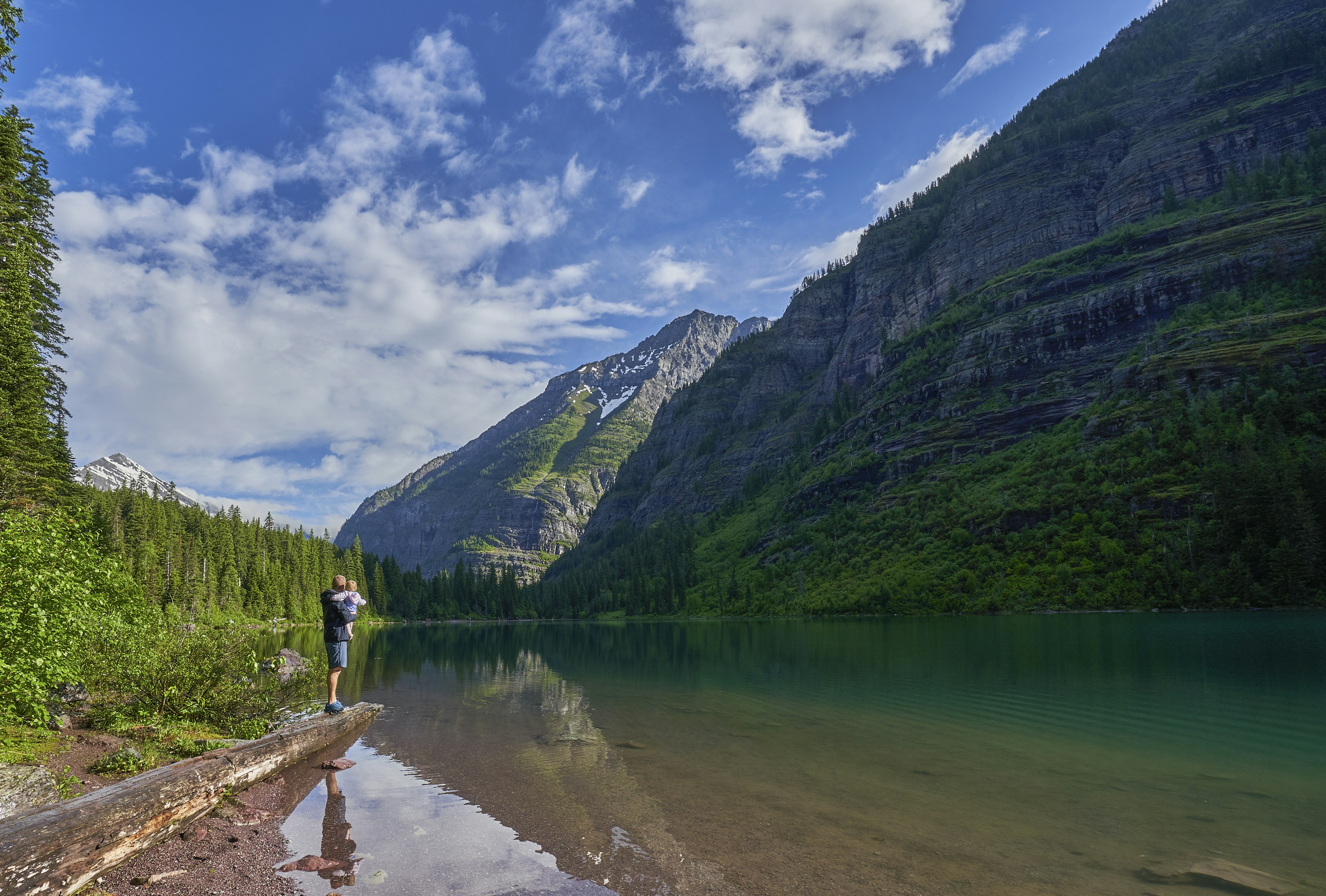 Family on the shore of Avalanche Lake in Glacier National Park