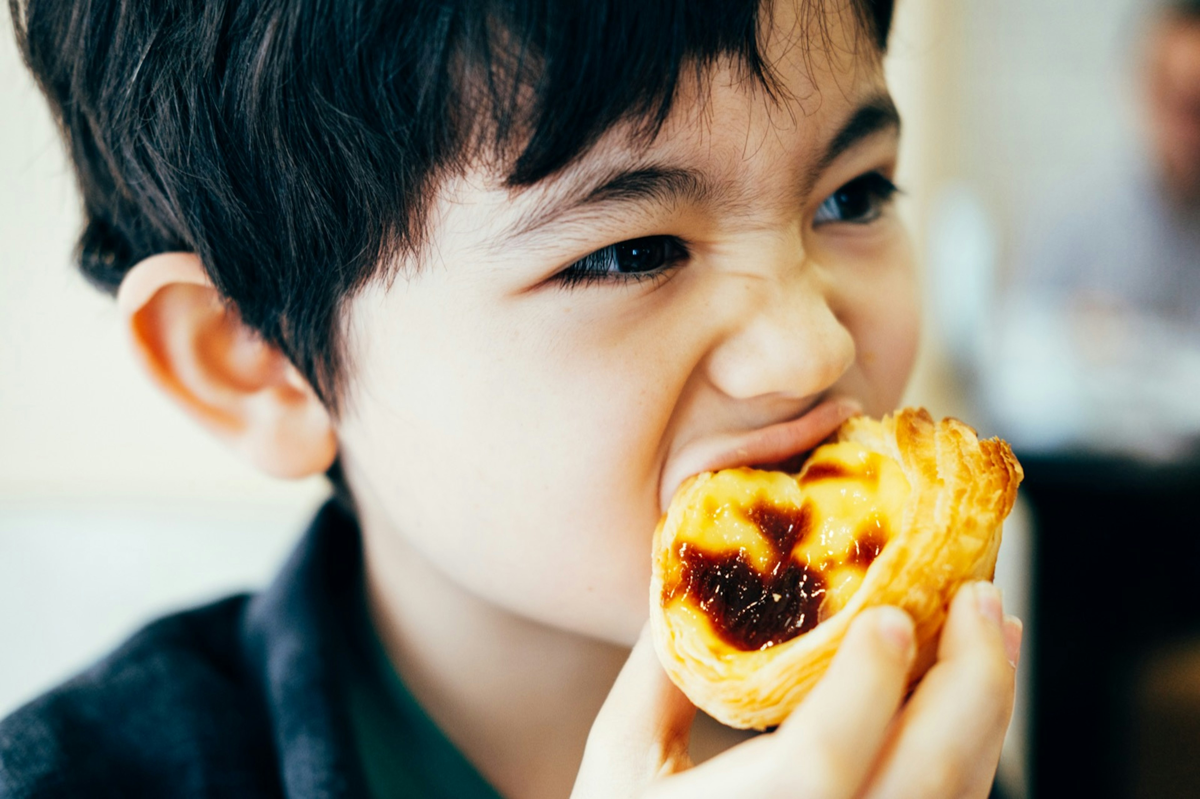 Boy eating pastel de nata