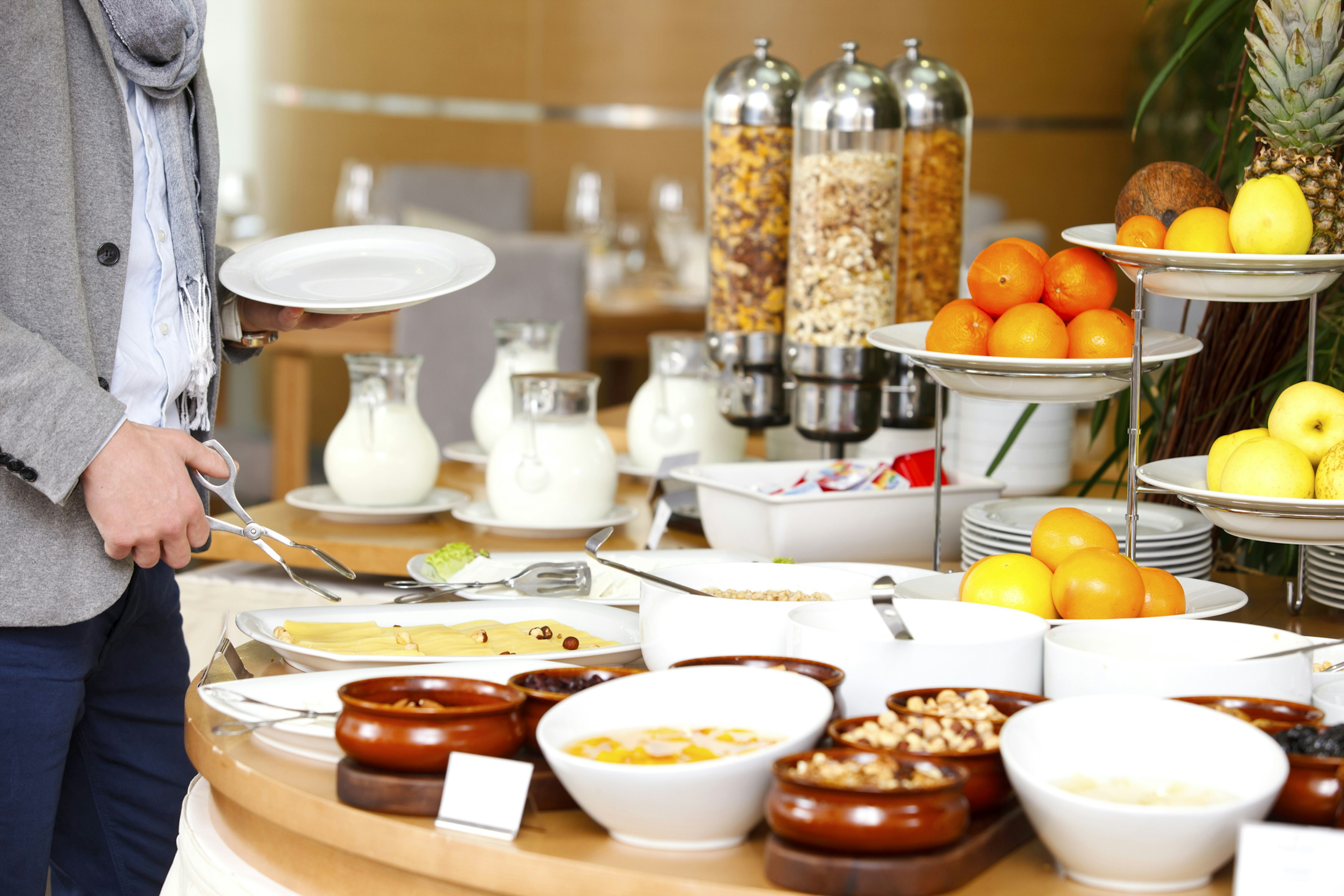 Man selecting his meal from a breakfast buffet