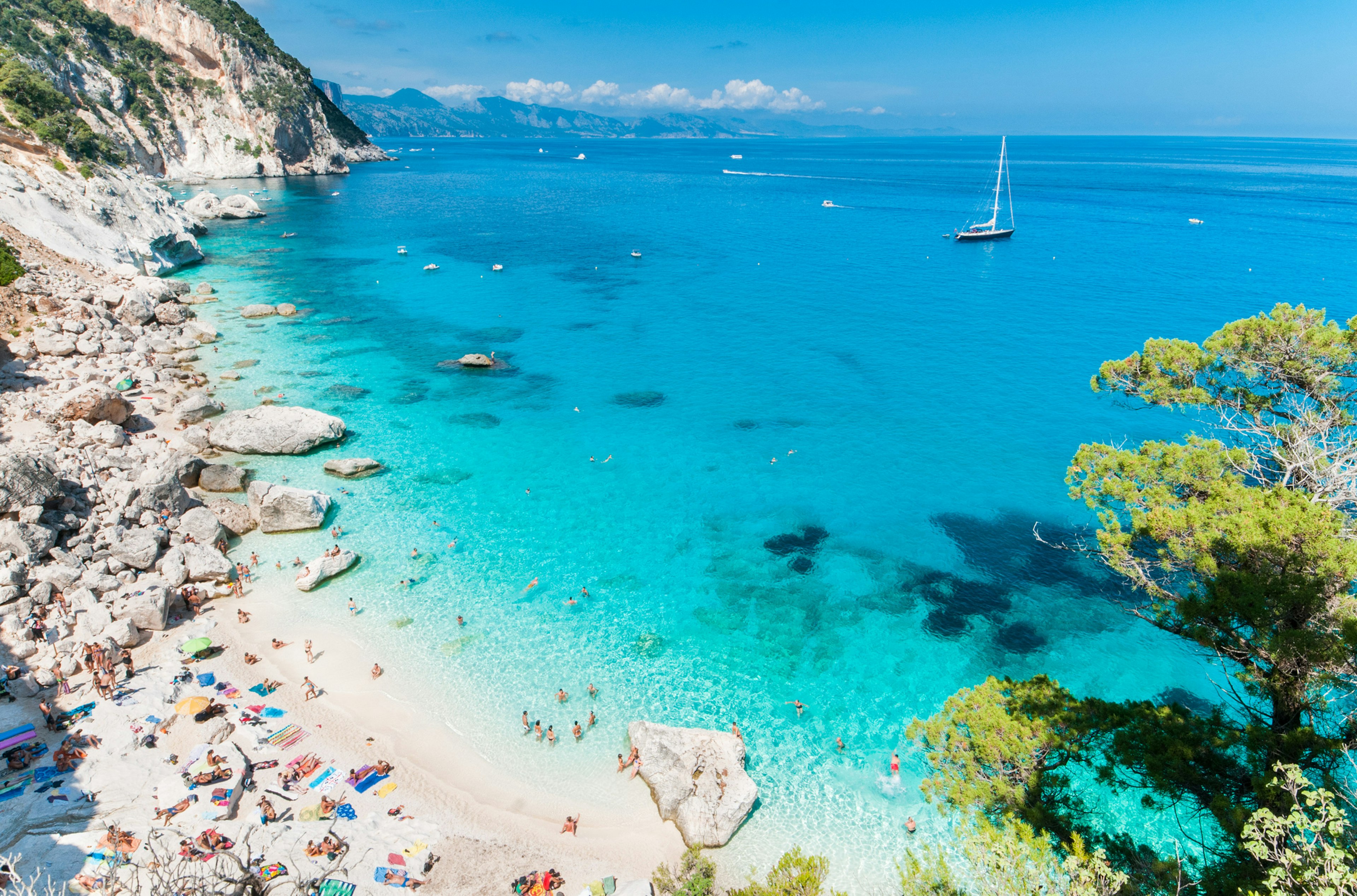 A cliff-backed beach with turquoise waters