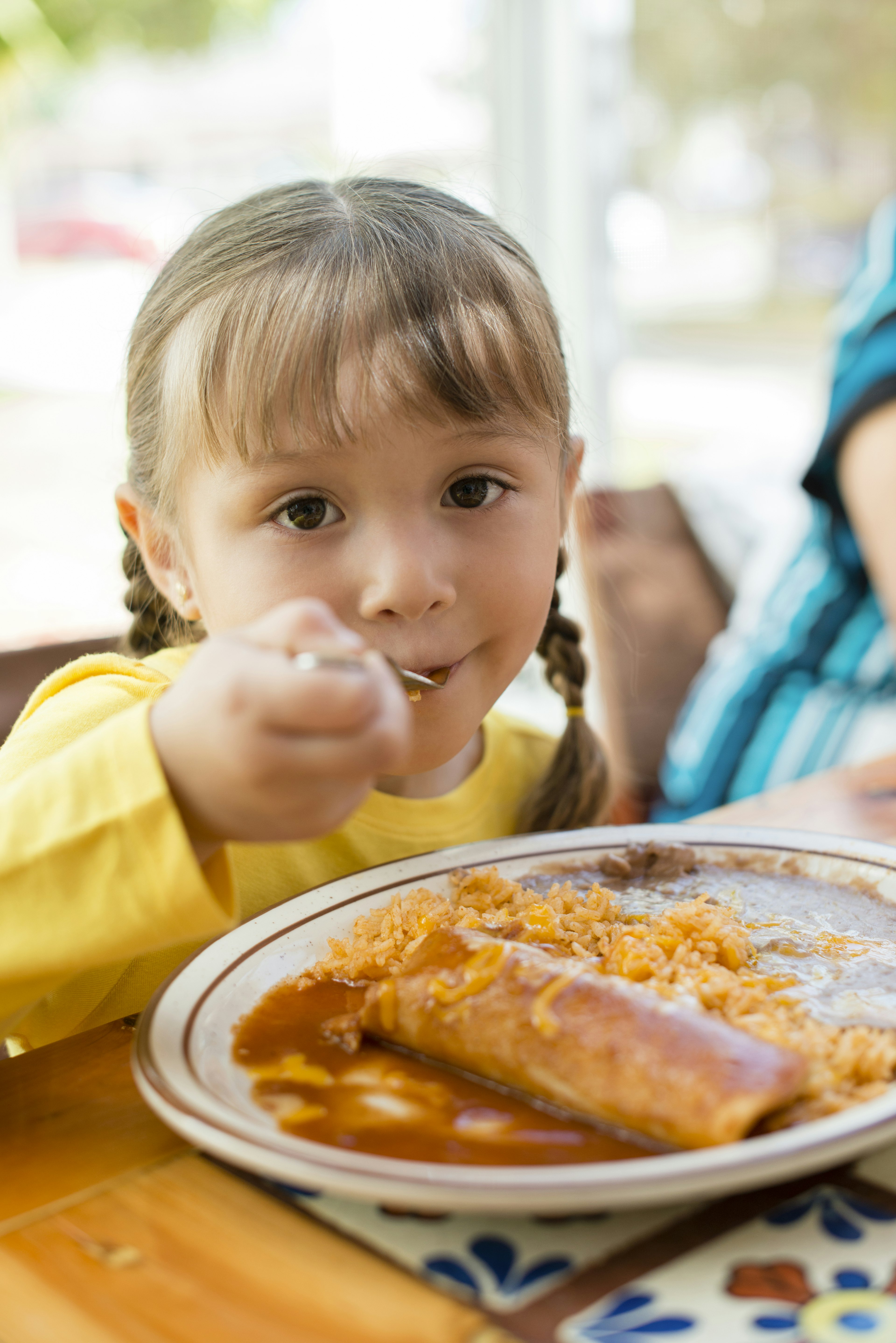 Girl eating dinner at table