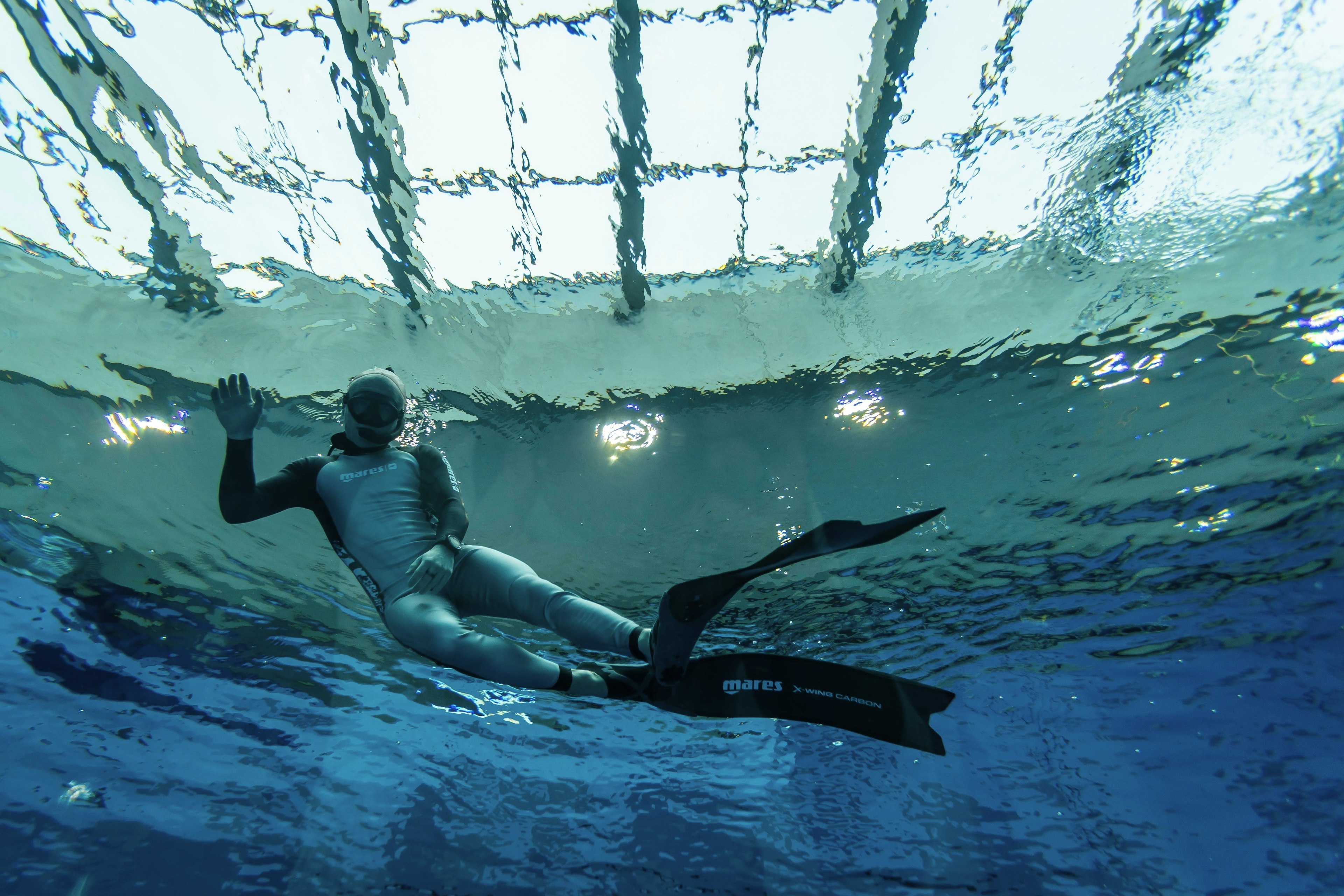 A diver breaks the surface of the Deepspot pool