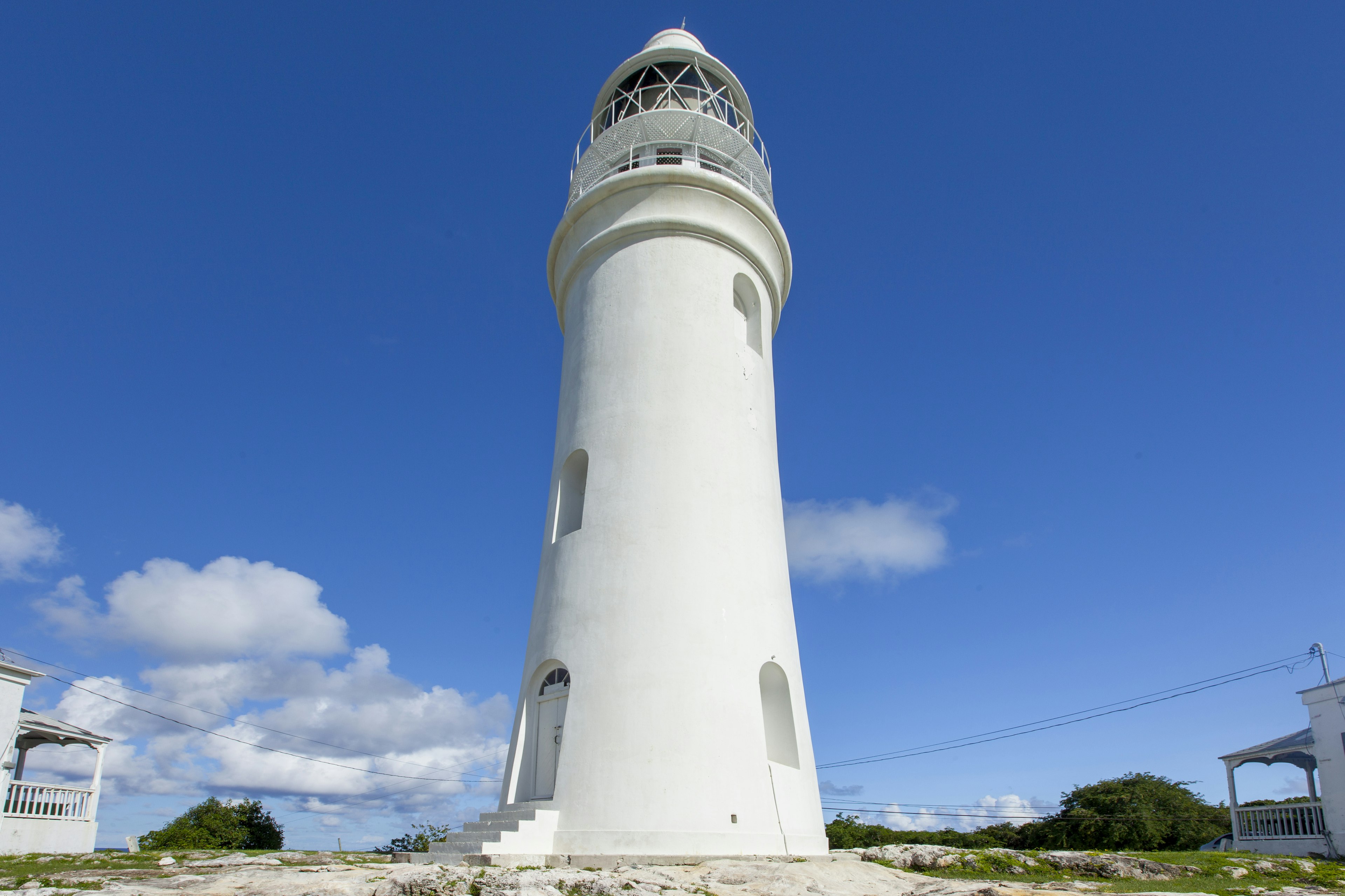 Exterior shot of the white, stone Dixon Hill Lighthouse in San Salvador, Bahamas