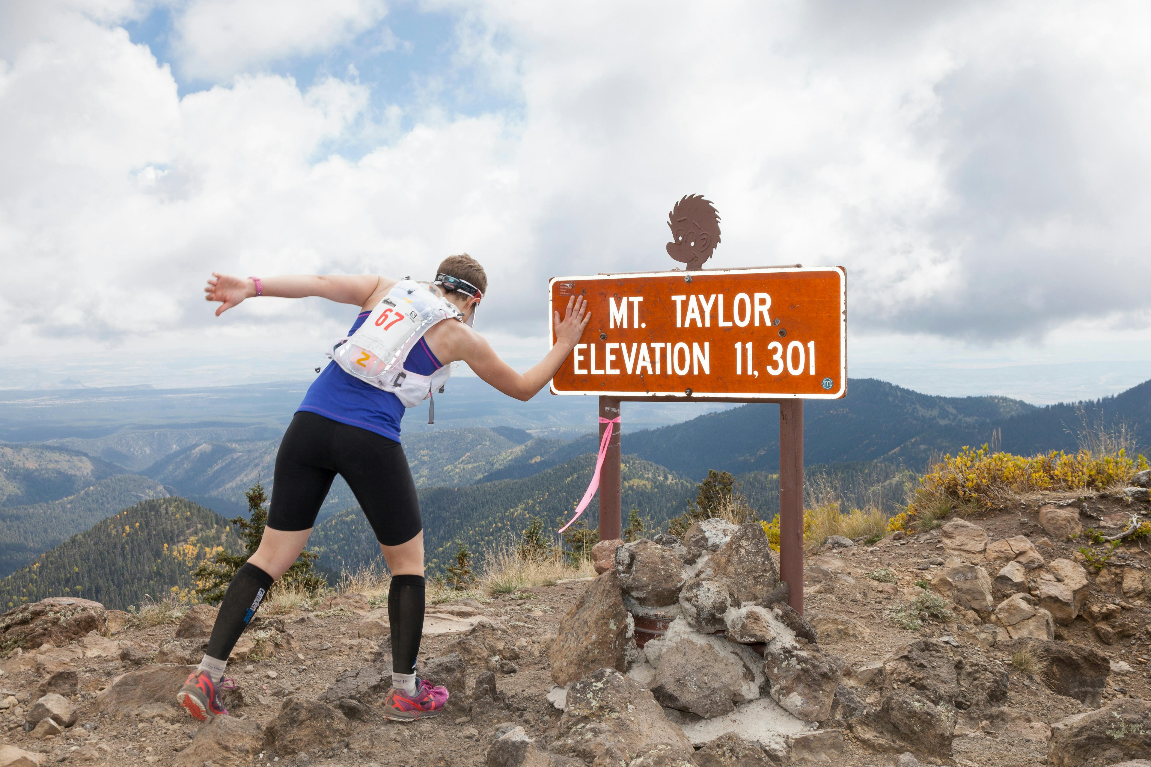 Runner reaches the summit during the Mt Taylor 50k - Mt Taylor, San Mateo Mountains, Cibola National Forest, New Mexico, USA