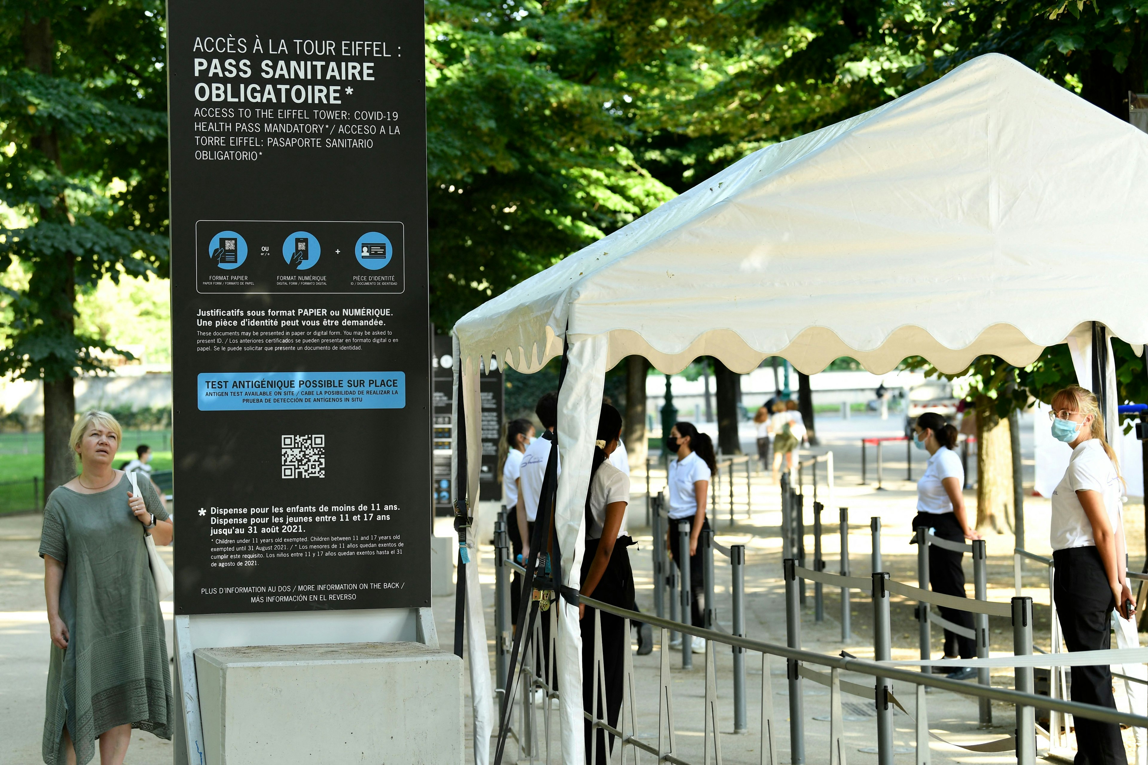 Employees of the Eiffel Tower check clients' health passes before they visit the Eiffel Tower