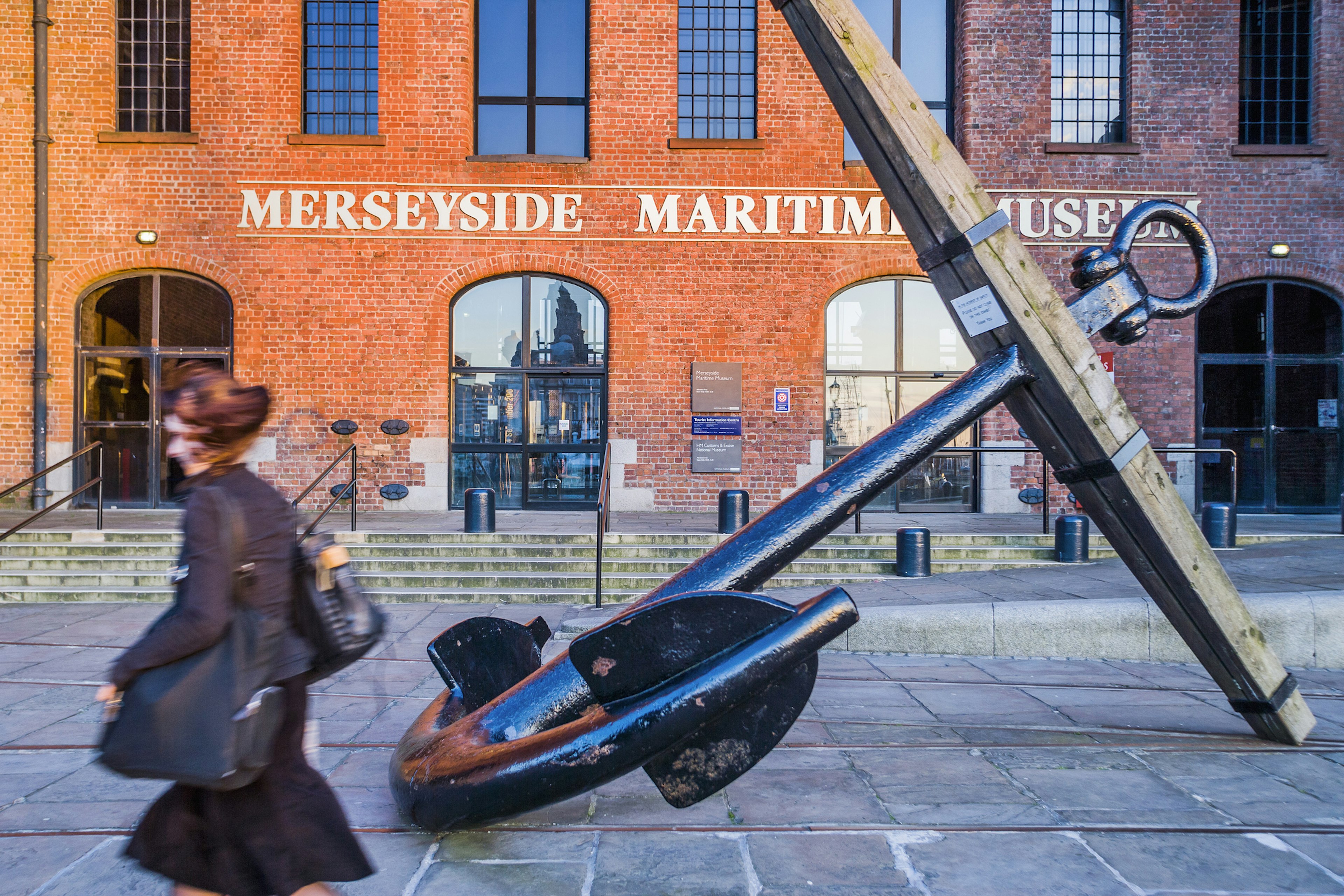 The entrance of the Merseyside Maritime Museum with a giant anchor outside it