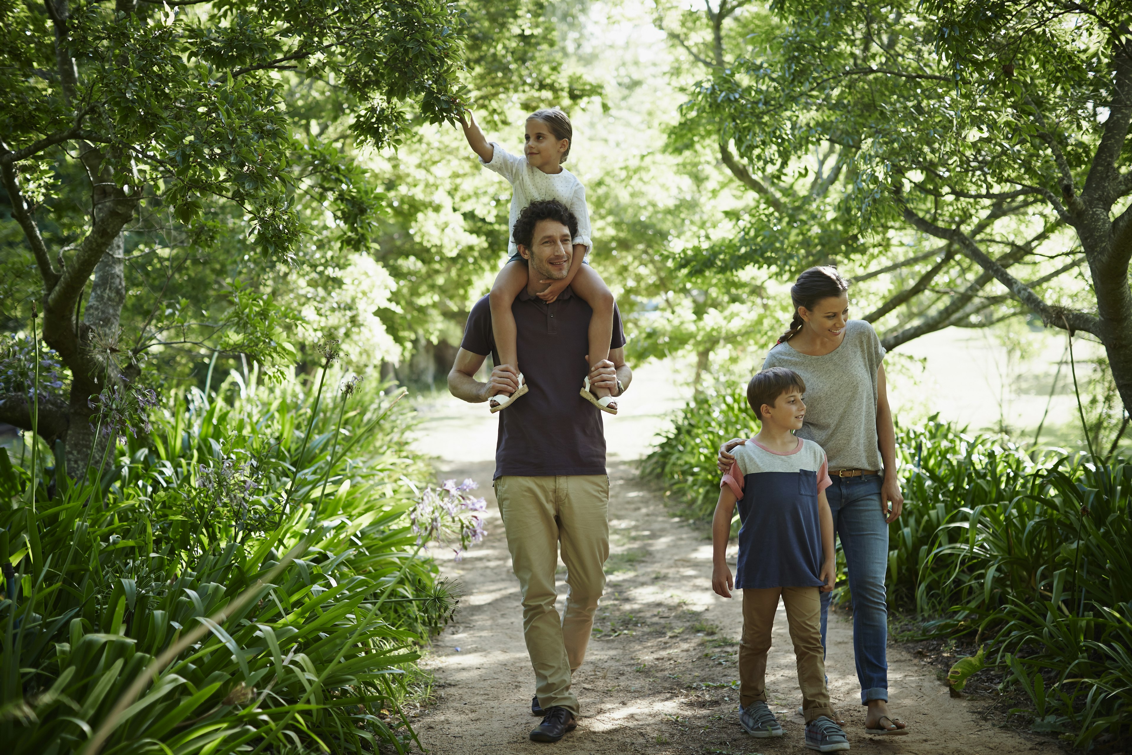 Two generation family walking in park