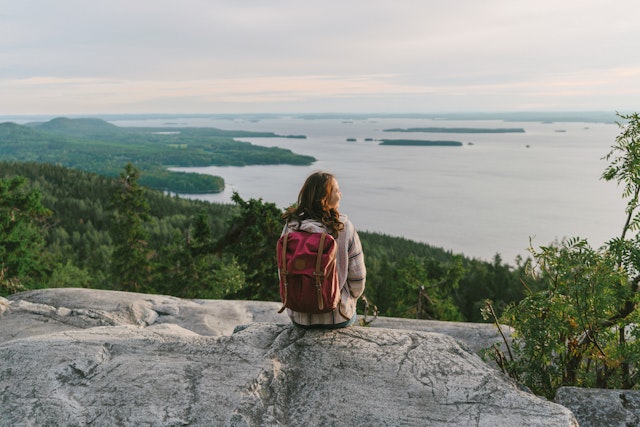 Scenic view of woman looking at a lake in Finland