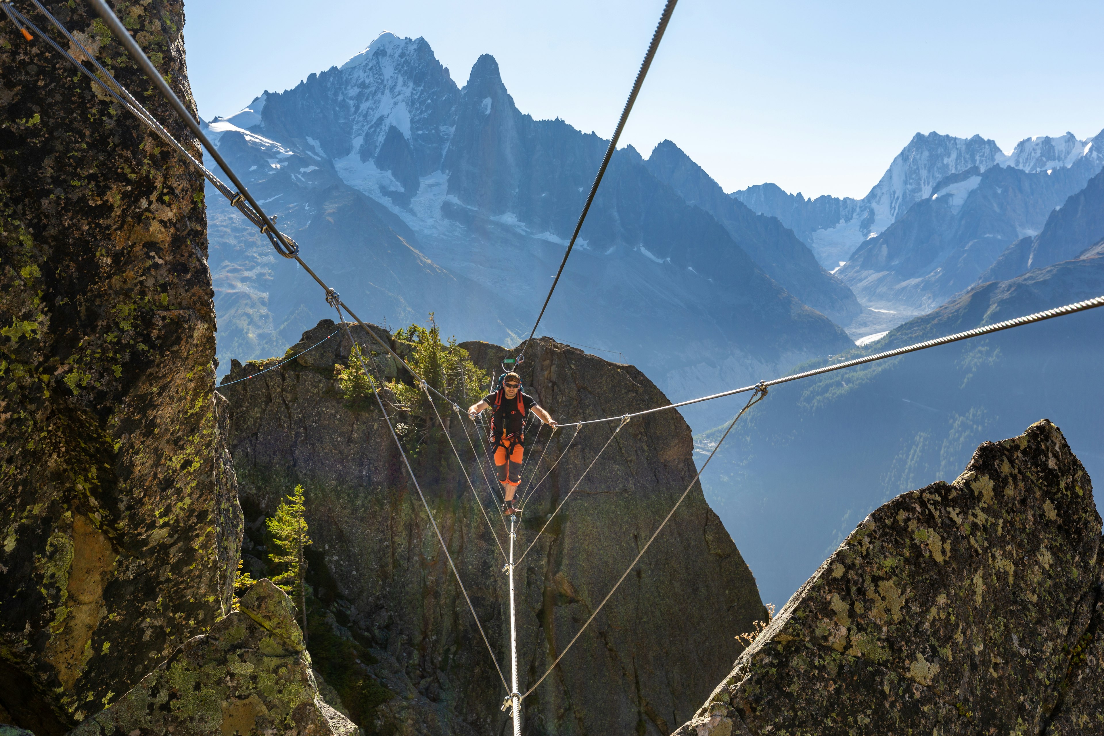 Crossing a chasm by via ferrata in Des Evettes La Flegere, Chamonix