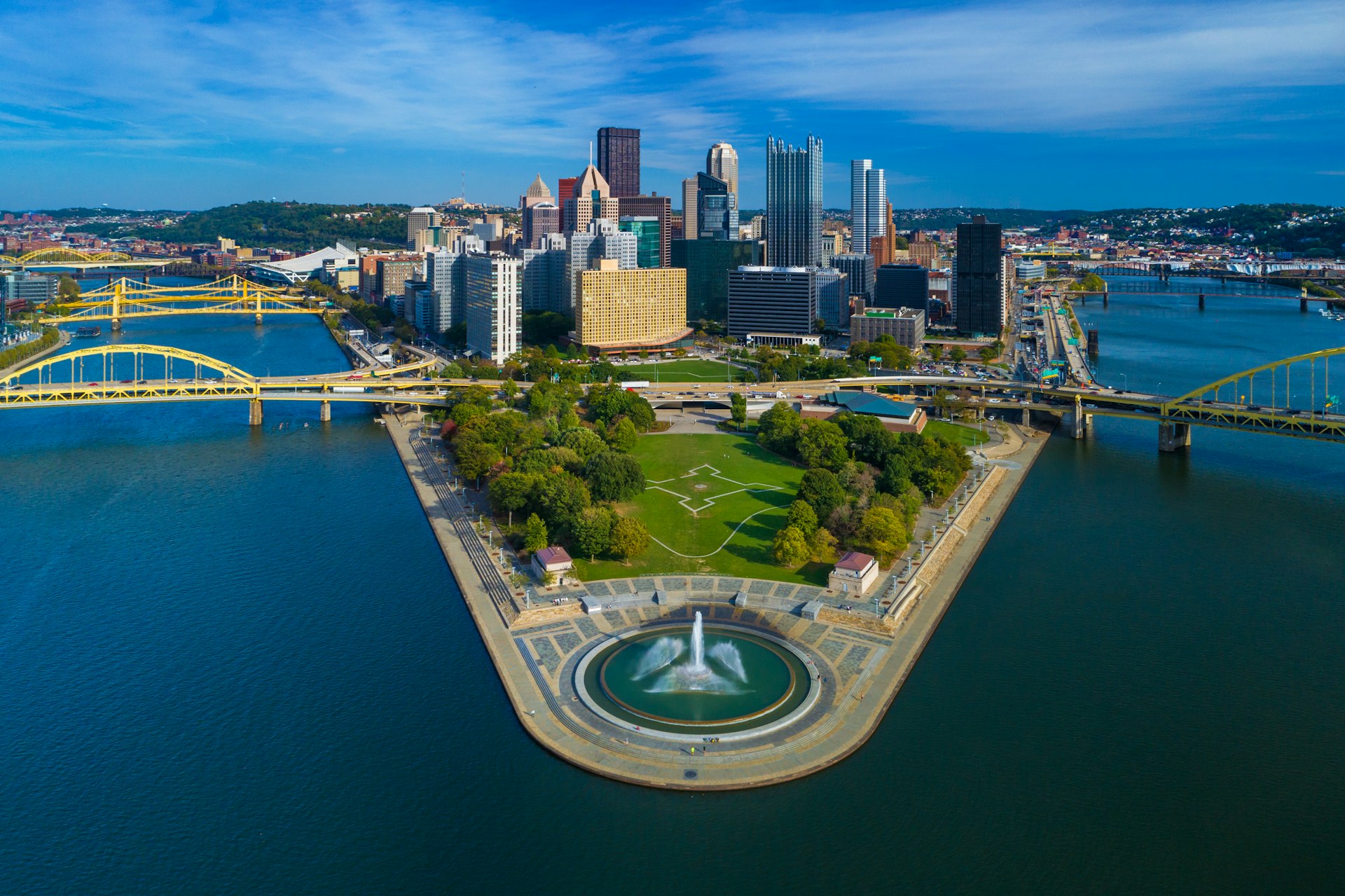 An aerial view of Downtown Pittsburgh with Fort Duquesne (including a fountain) and Point State Park