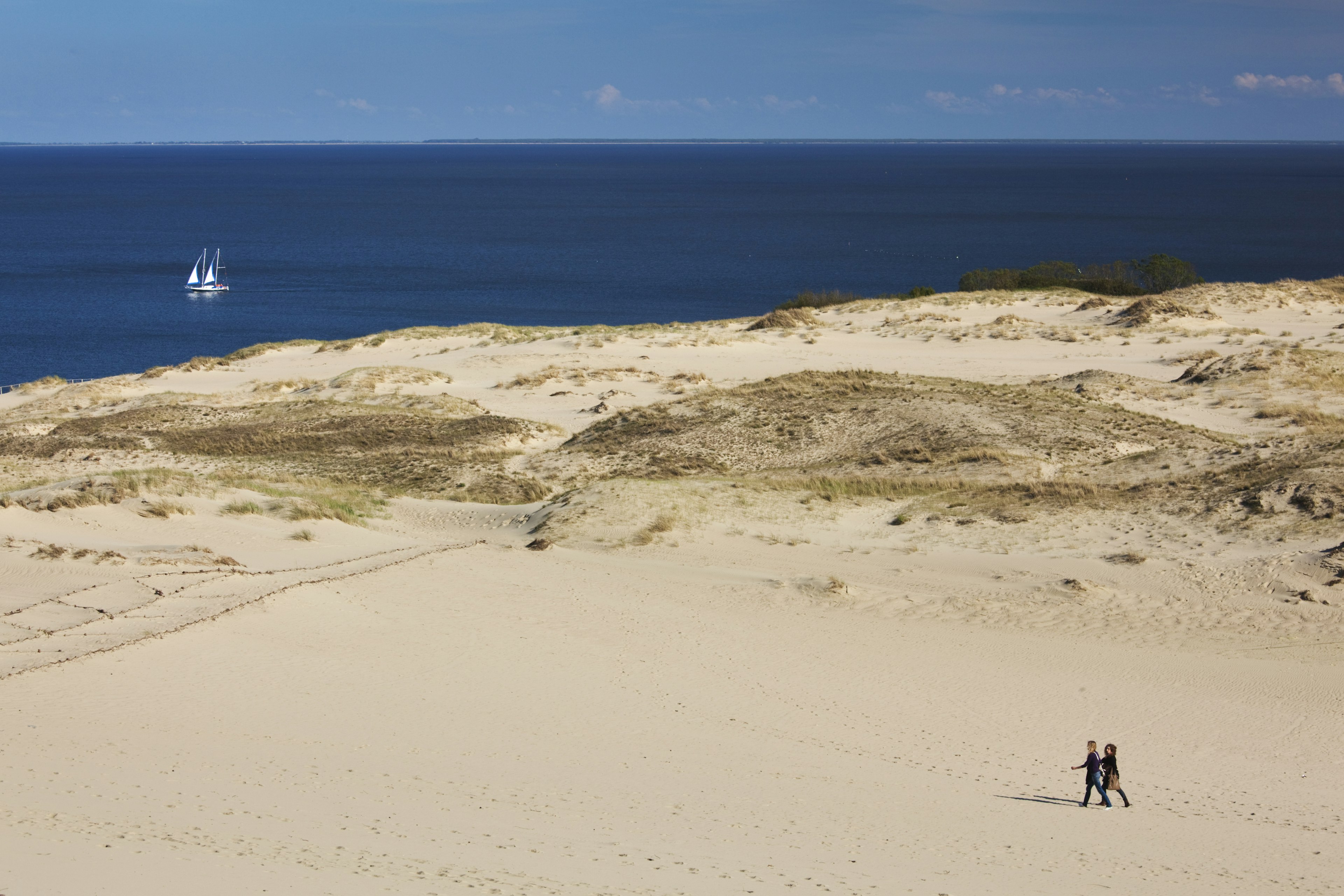 An aerial view of two people on the Parnidis Dune, on the Curonian Spit, Lithuania