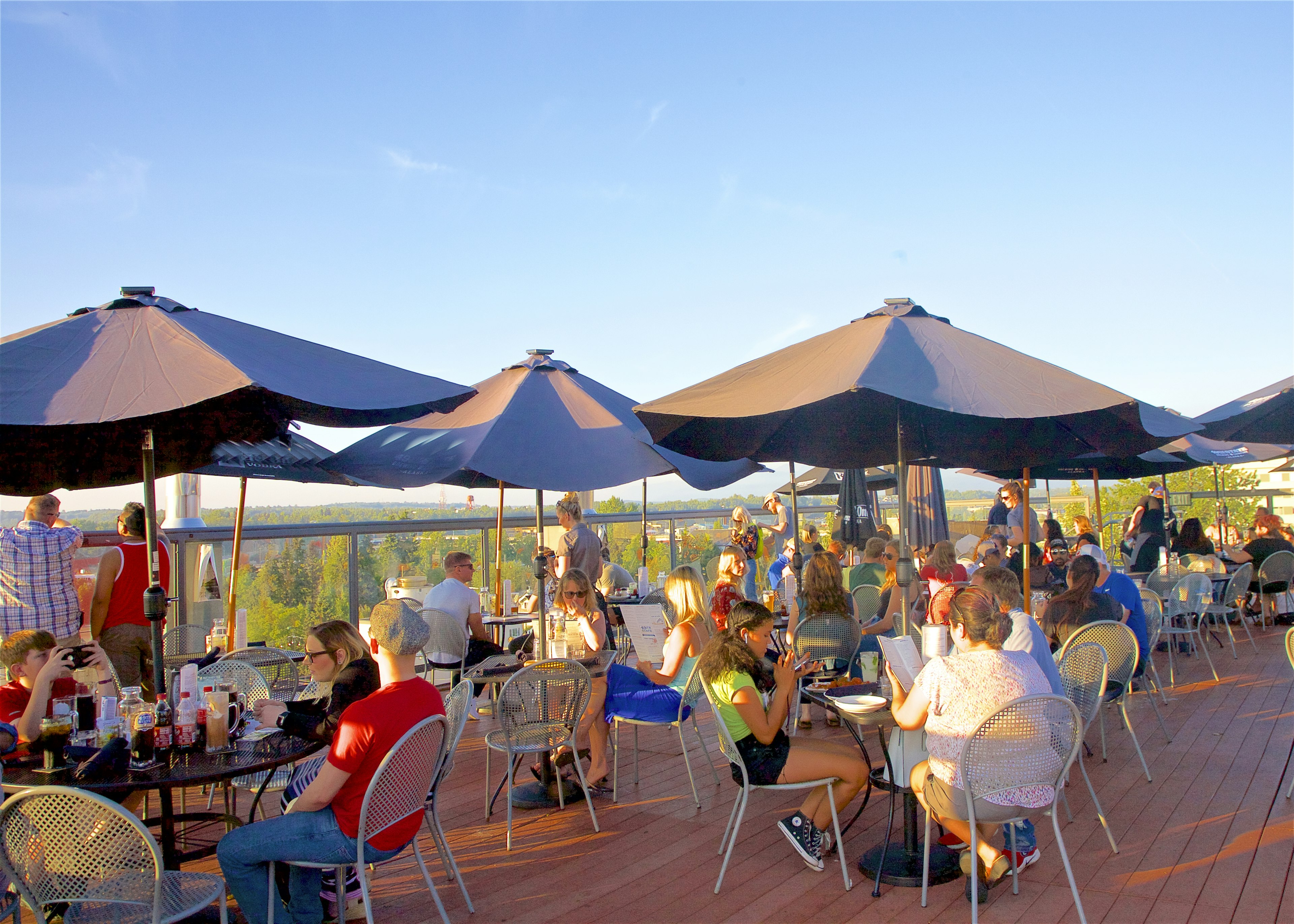 Adults having drinks on rooftop deck, Anchorage