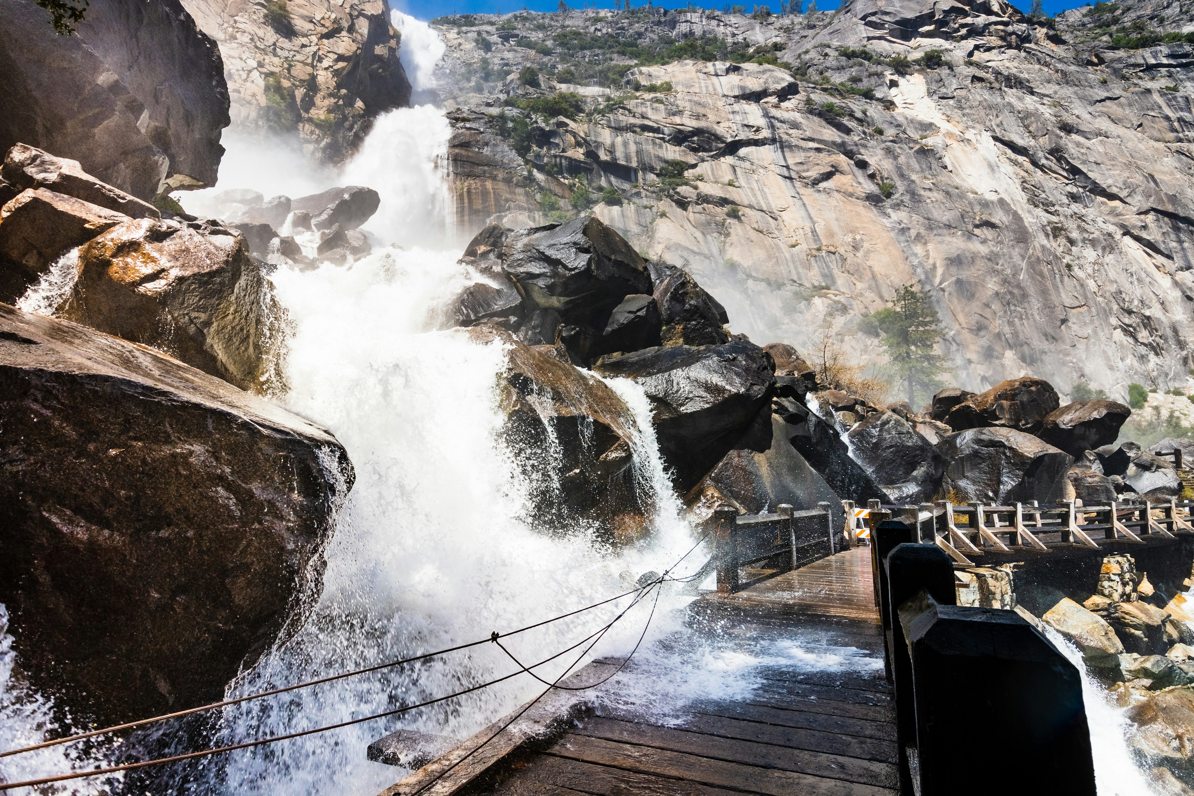 The Wapama Falls flow heavy over the footbridge in the Hetch Hetchy Reservoir area, Yosemite National Park