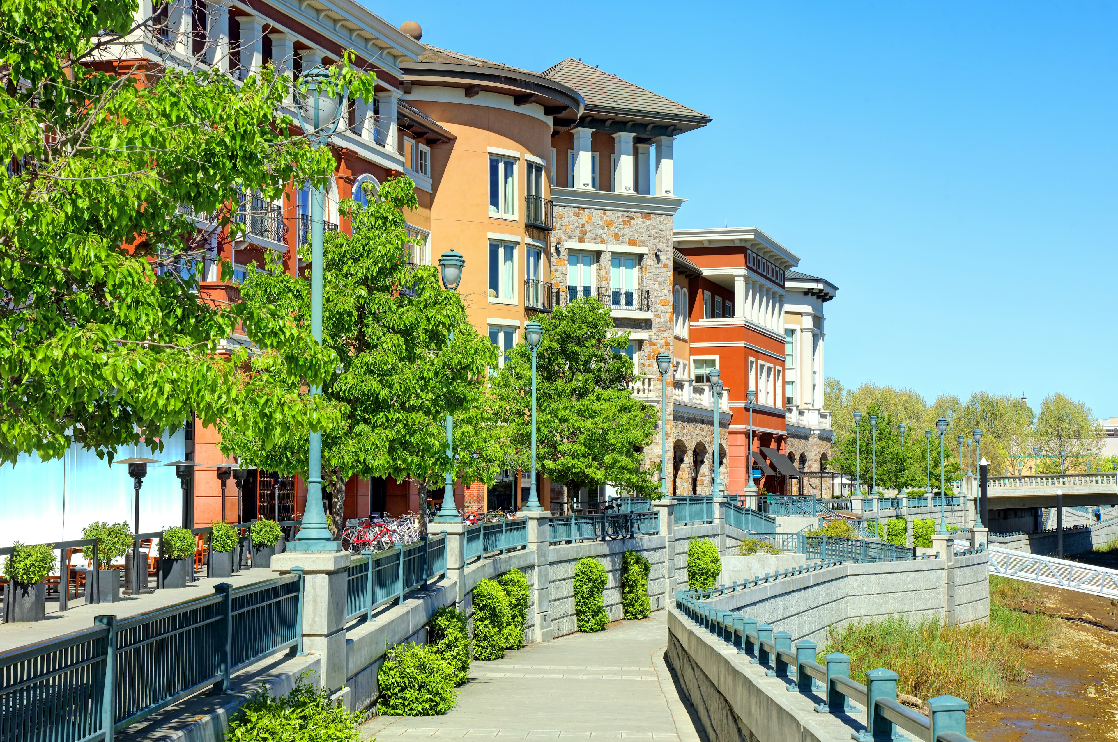 Pastel-coloured buildings lining a river in an urban area