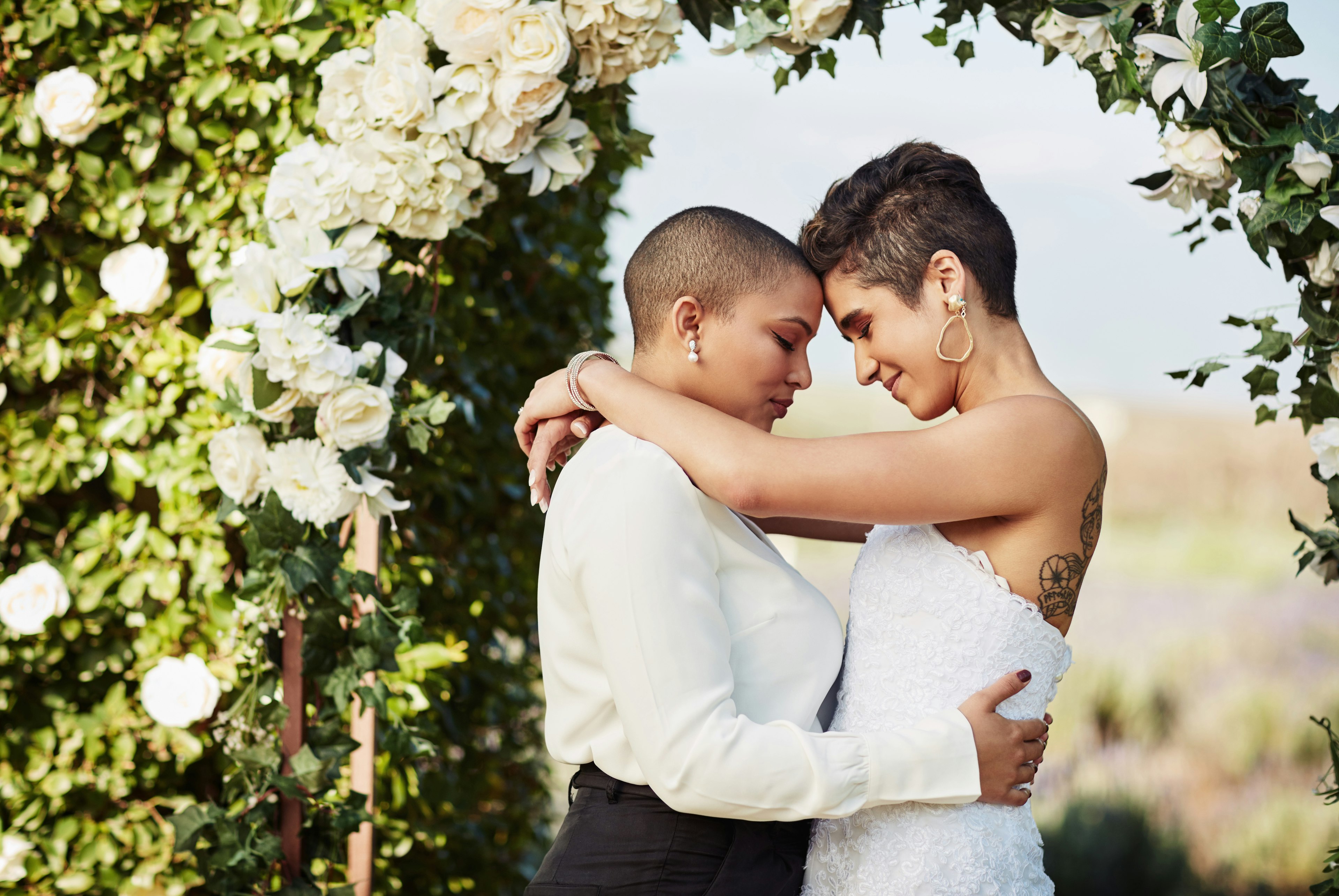 A lesbian couple shares an intimate moment on their wedding day