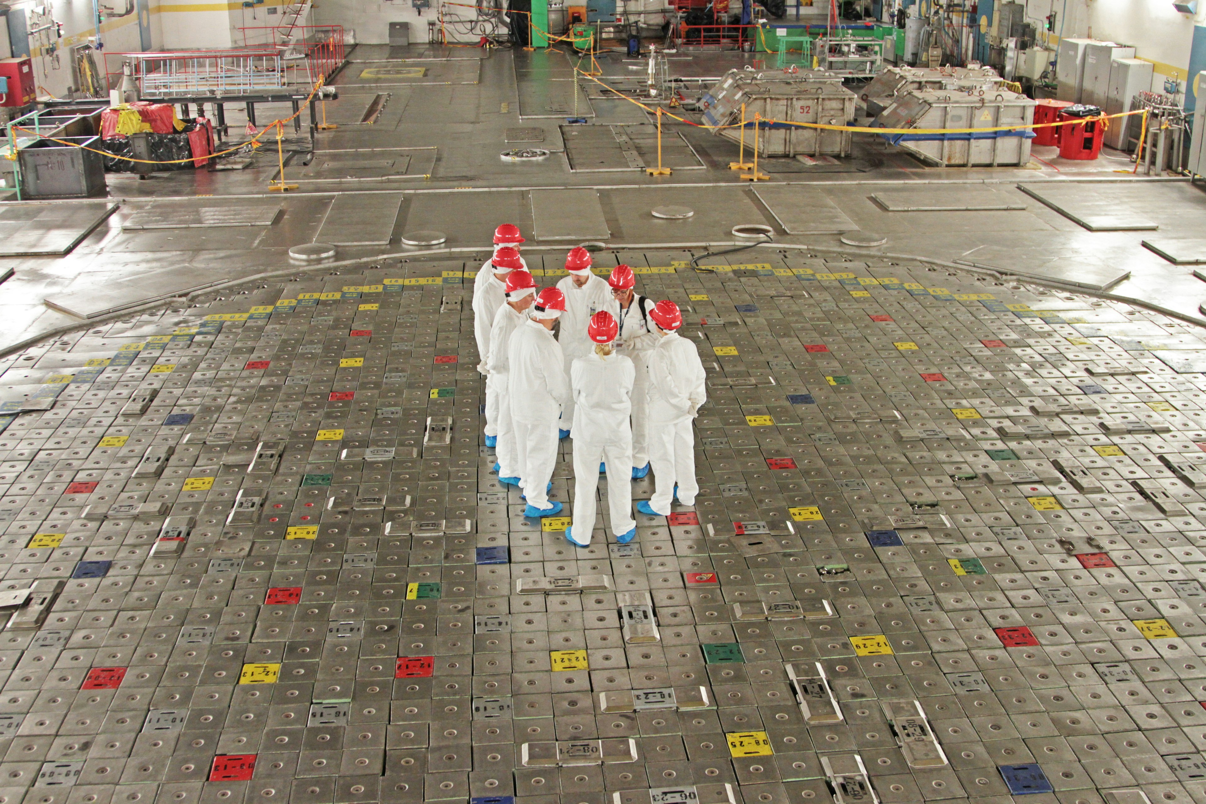 Visitors stand on top of the shut down nuclear reactor during a tour of the decommissioned Ignalina nuclear power plant