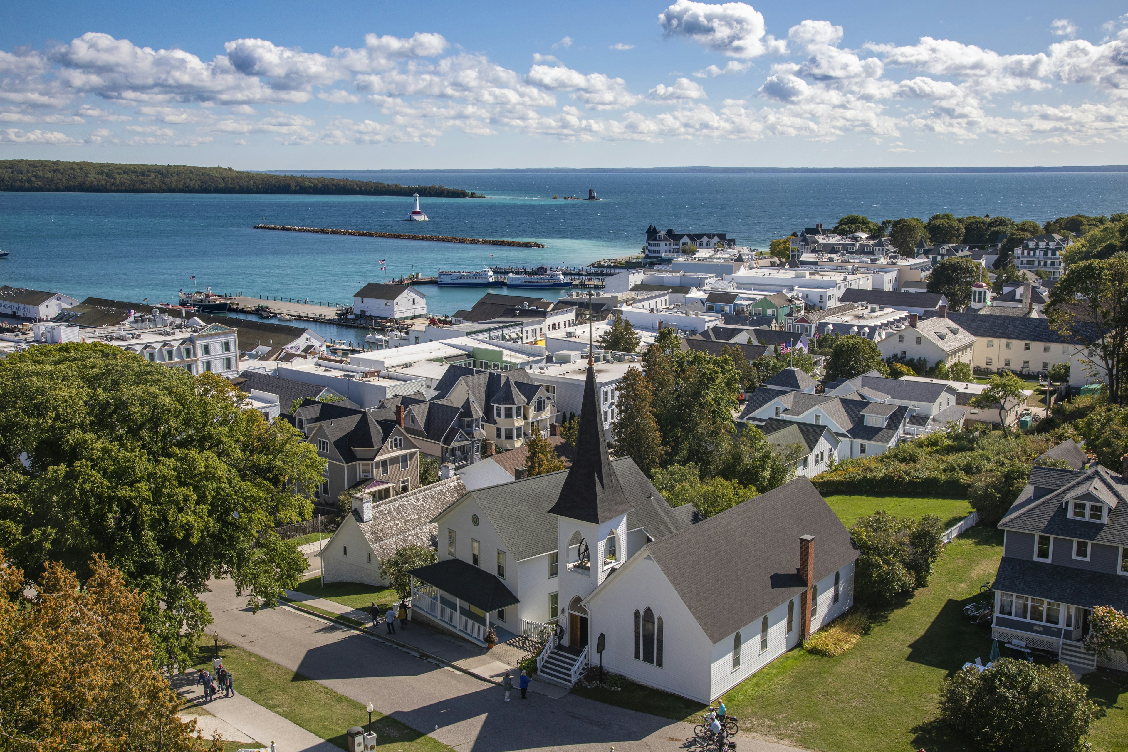 An aerial view of the main town on Mackinac Island, Michigan, with the blue waters of Lake Huron visible in the background