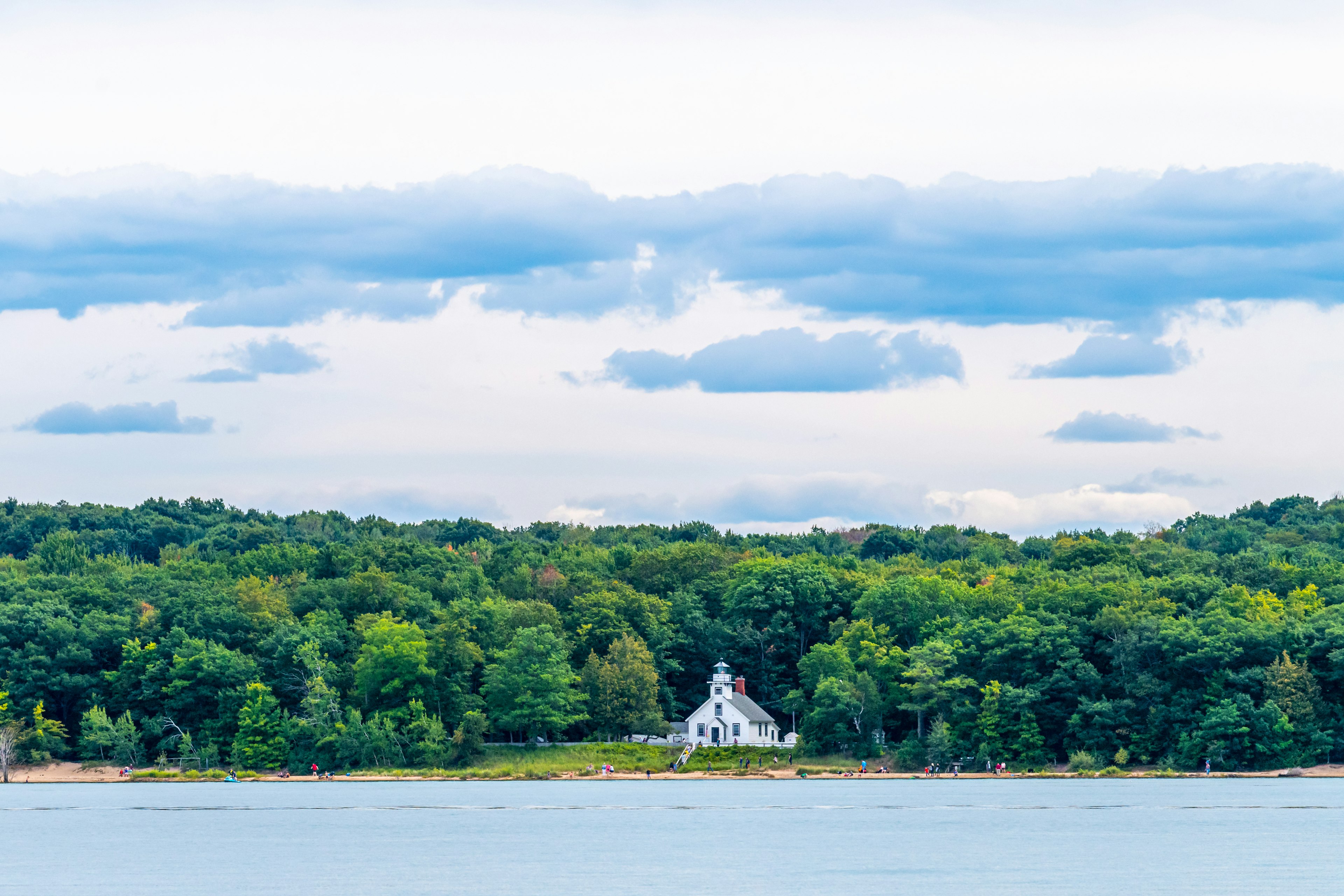 The Mission Point Lighthouse on the edge of a lake in Michigan