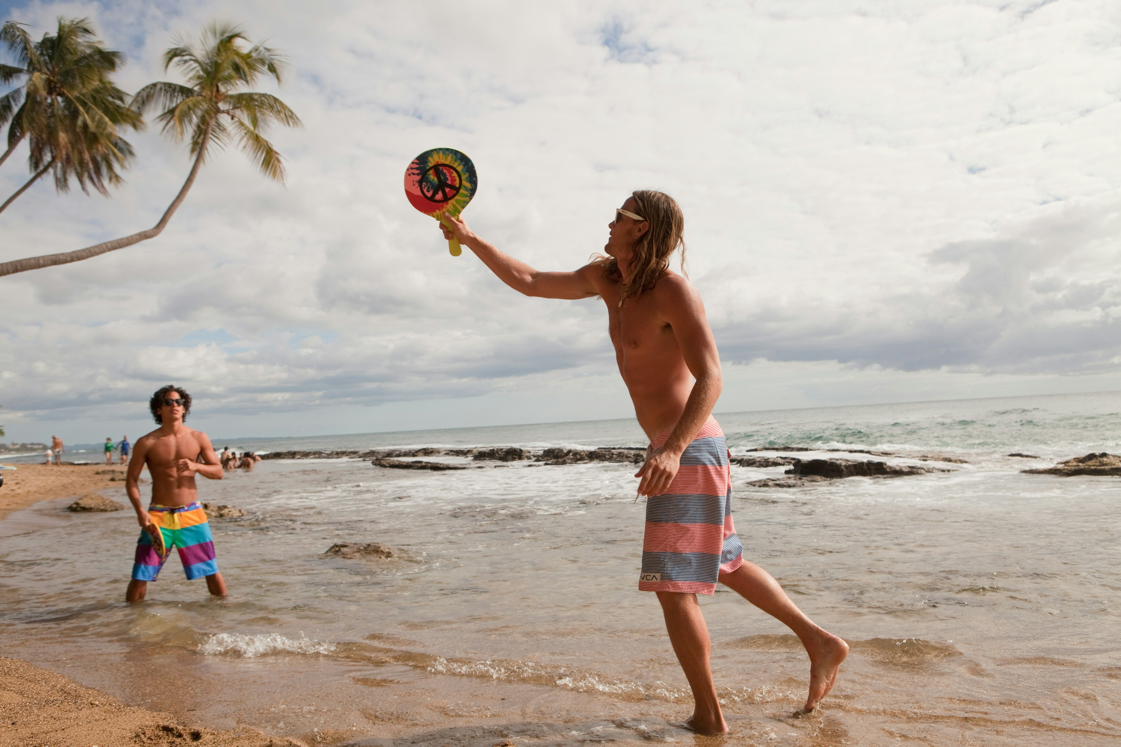 Young men playing ball games on the beach in Puerto Rico