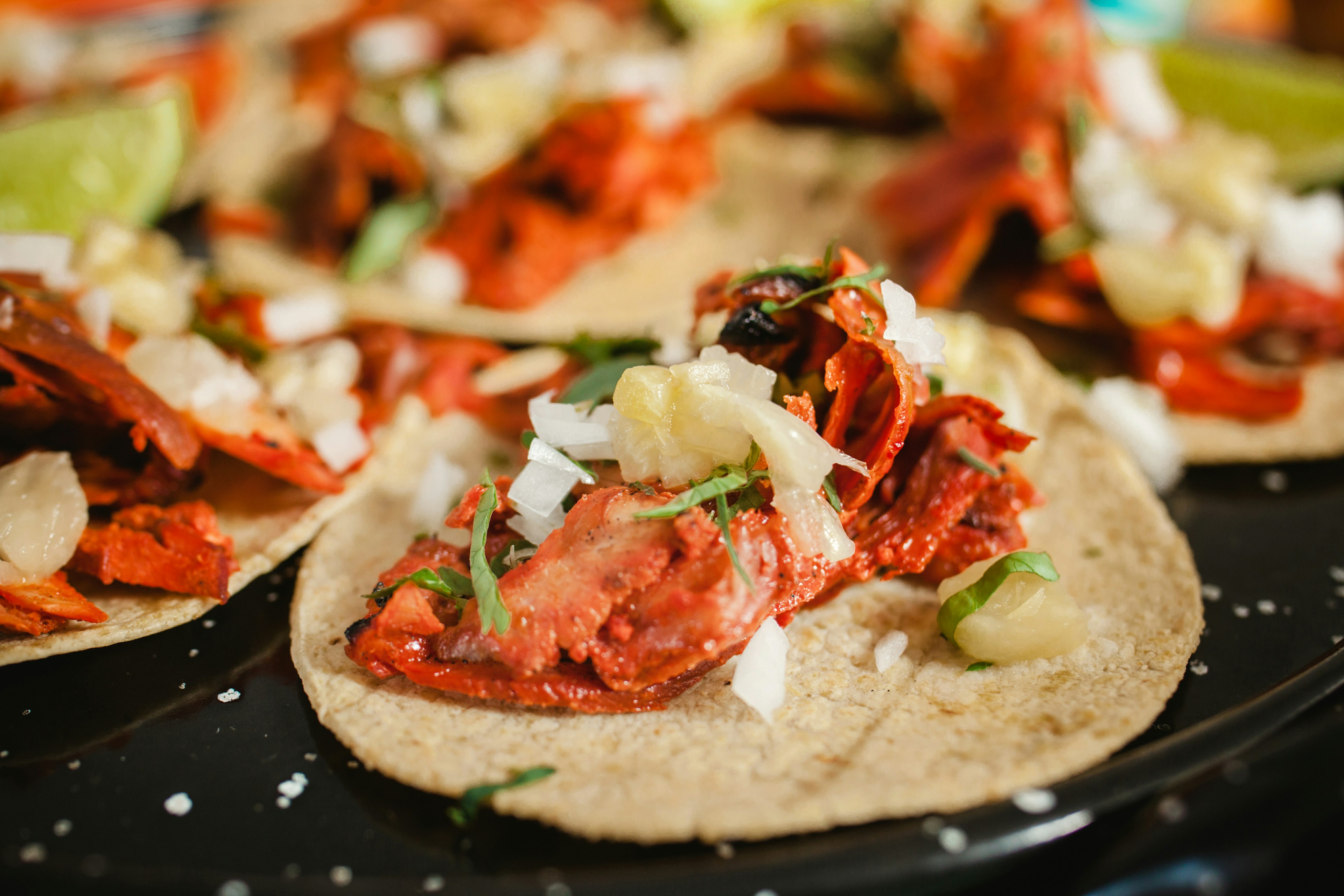 Fresh Mexican tacos al pastor with lemon and sauce in Mexico