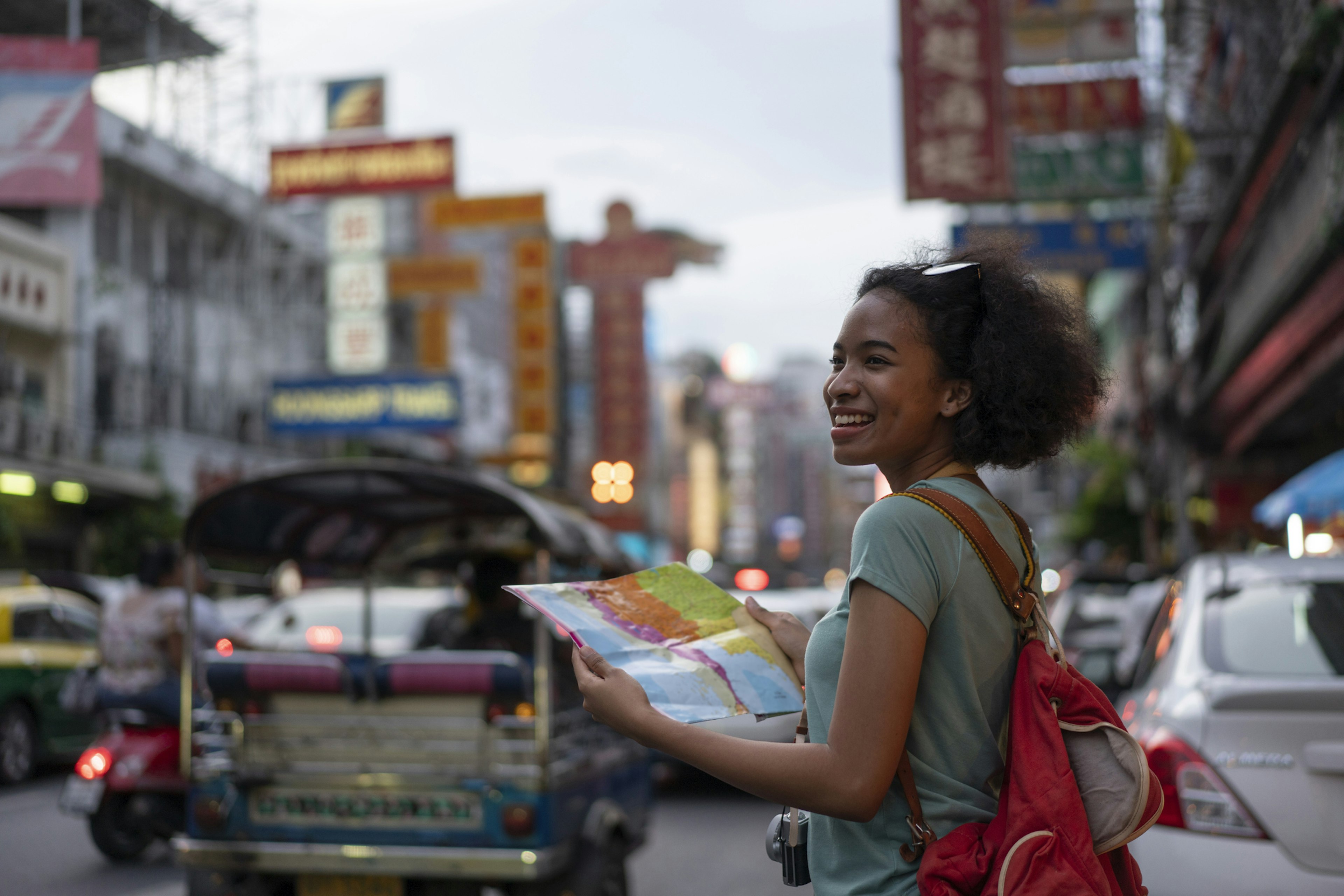 The back of a young woman walking and walking along the pedestrian street in the evening in Bangkok, Thailand, travelers and tourists