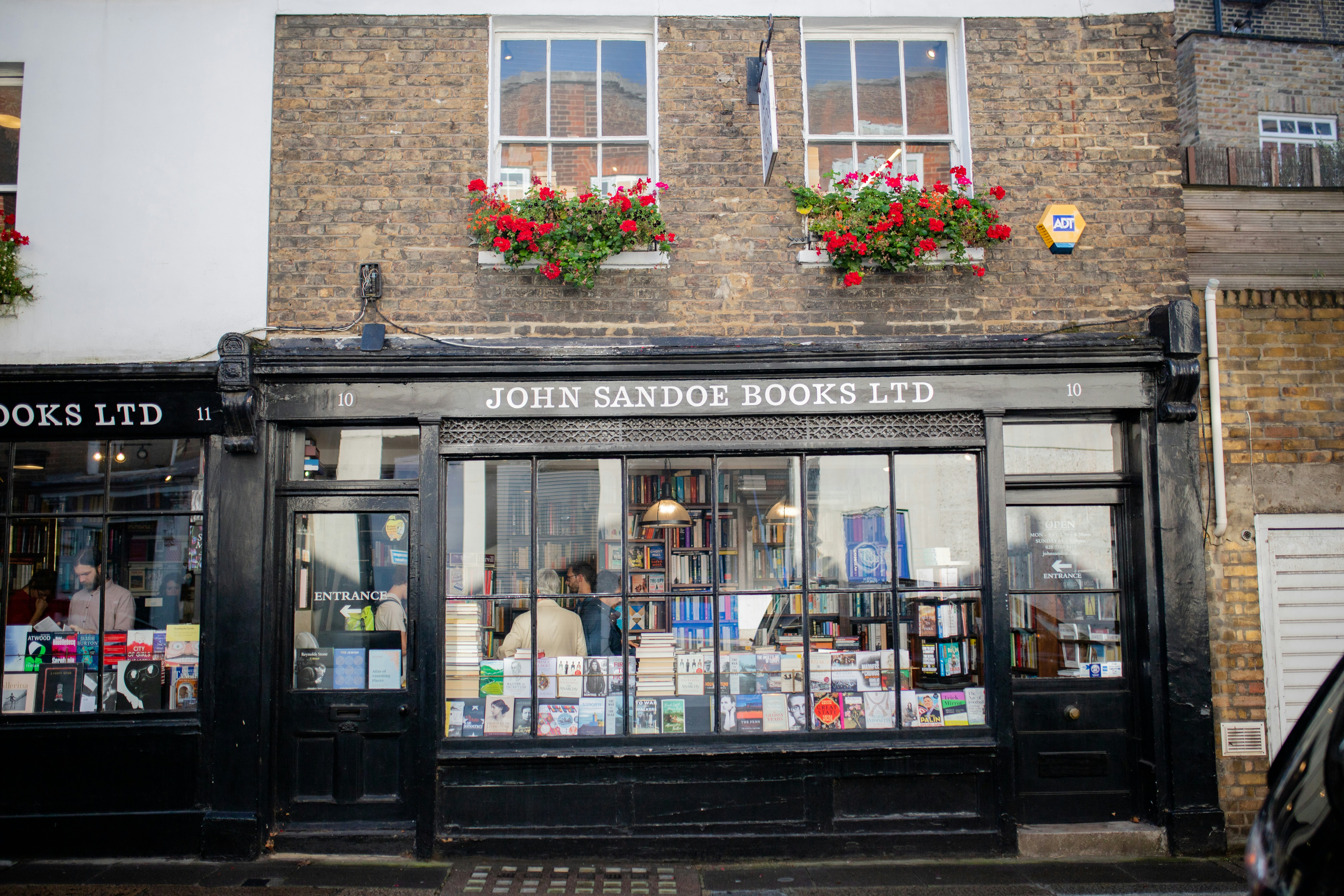 Landscape View of a Black Bookstore on the First Floor of a Red Brick Building