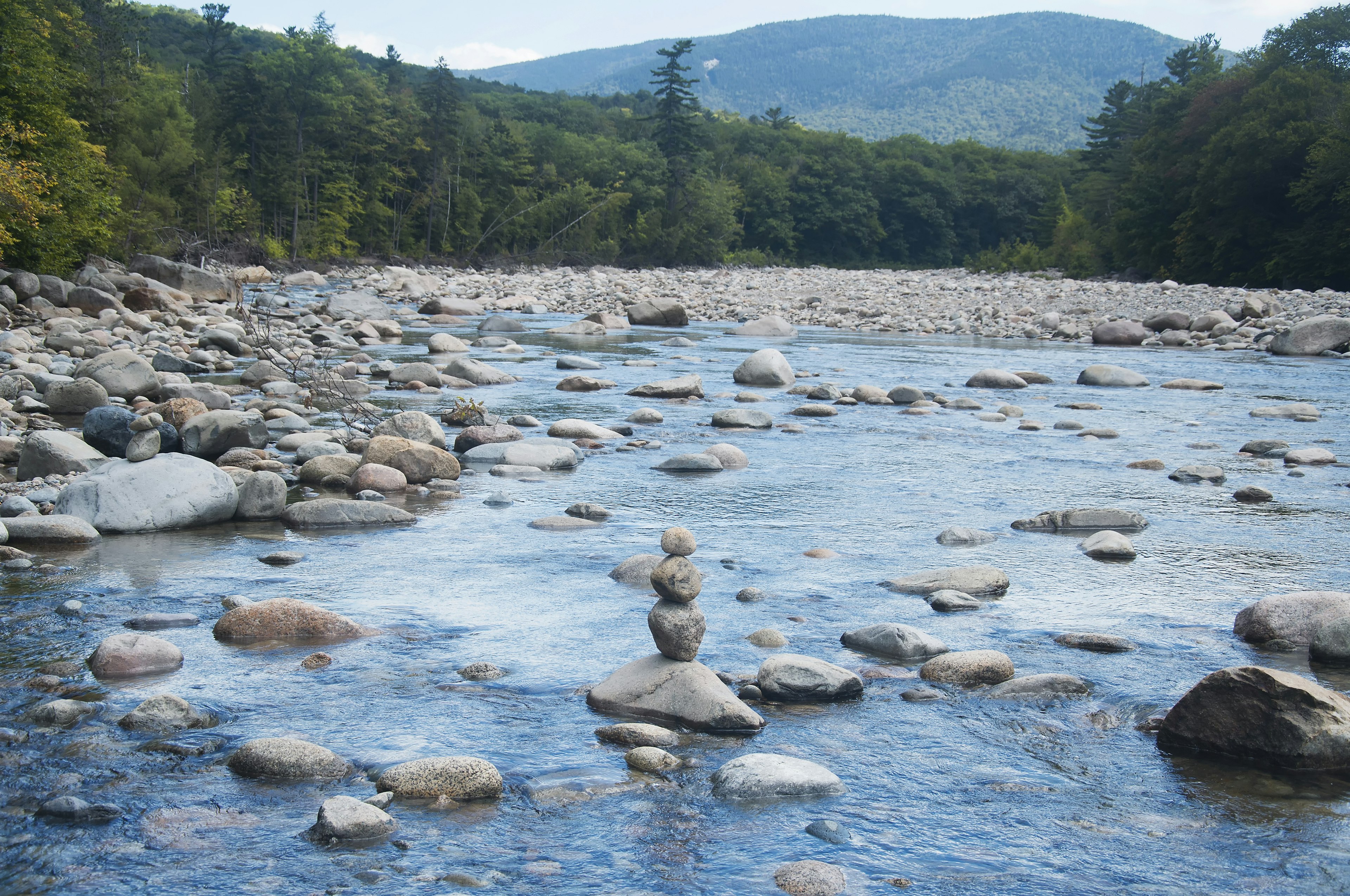 A rock cairn in the middle of a river