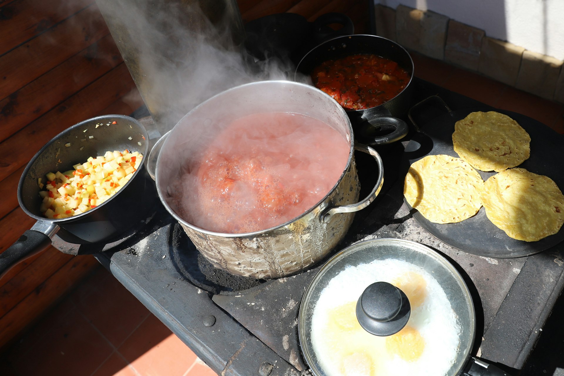 Beans, sunny side up eggs, tortillas, tomato sauce and chayote picadillo being. 