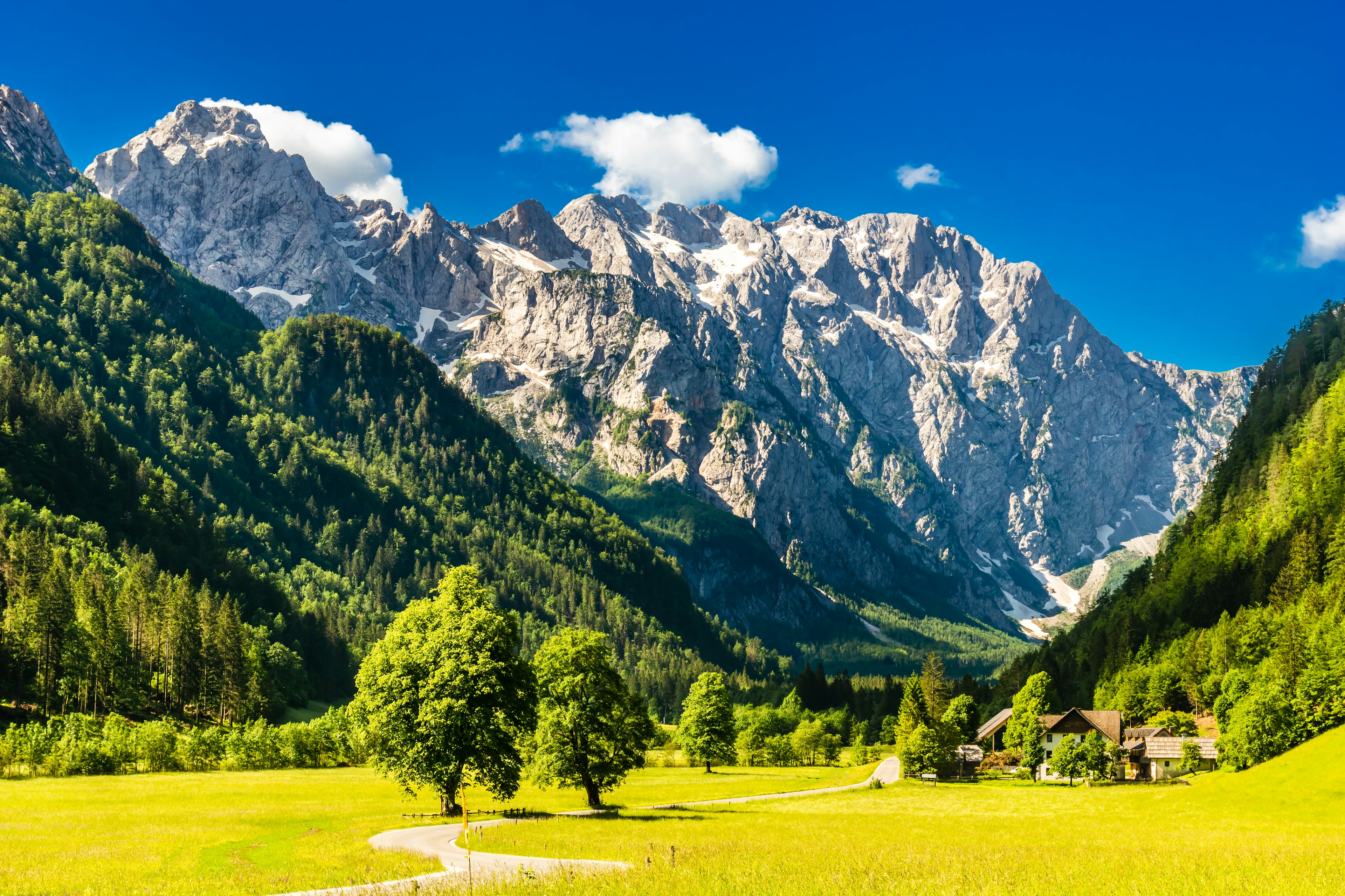 Sunlight meadows and mountains in the Logar Valley