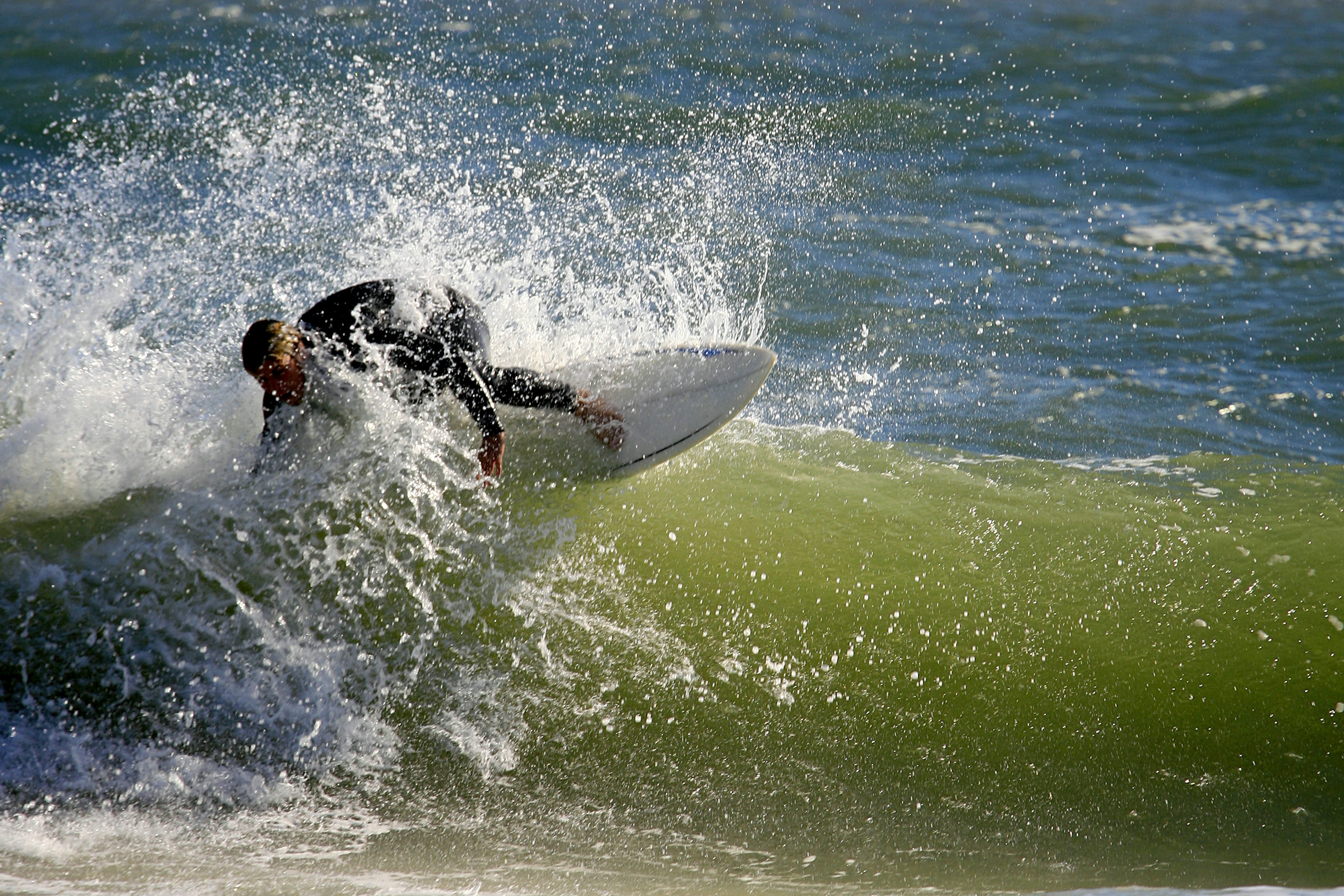 A surfer hitting a wave