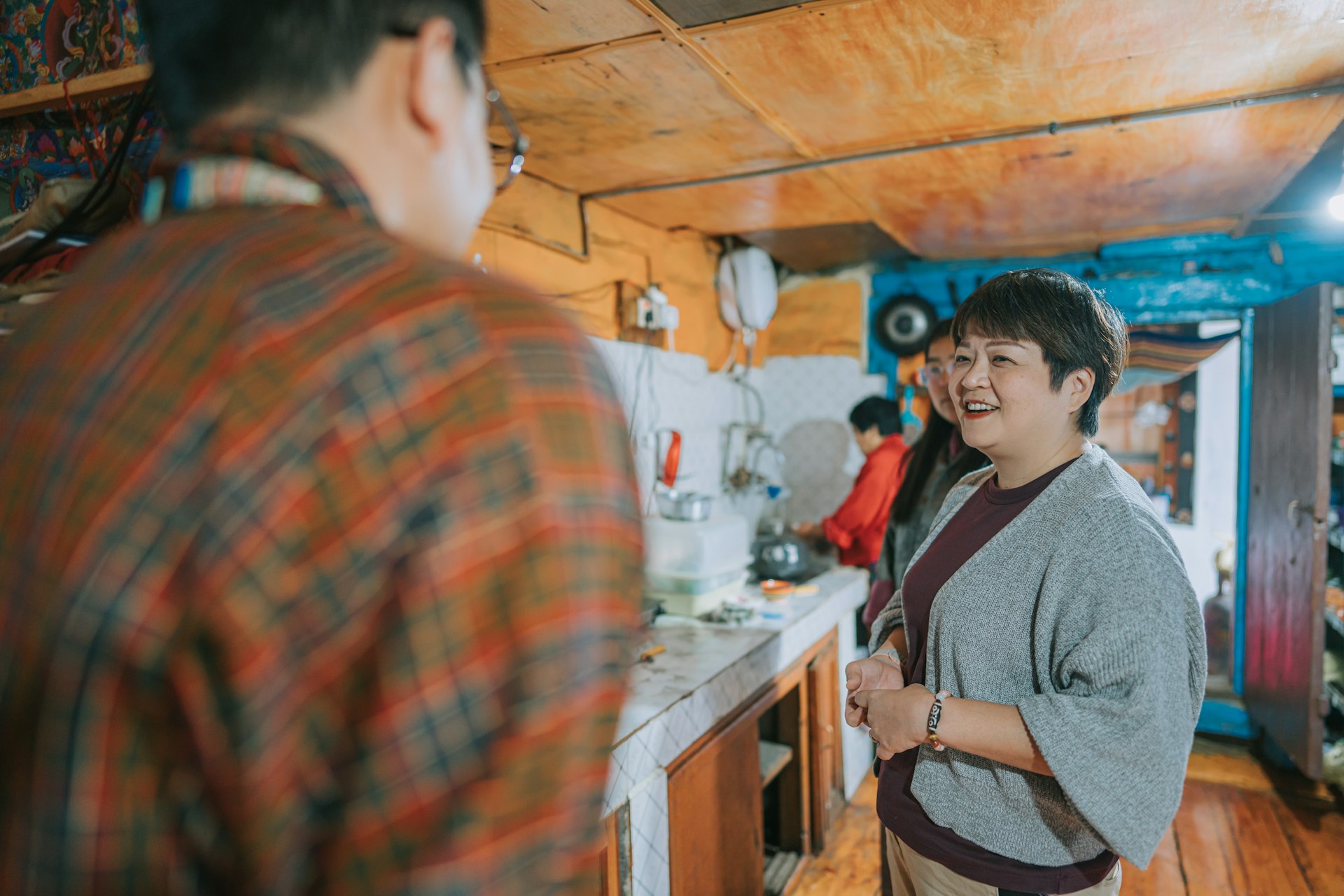 A tourist talks to a Bhutanese man during a homestay in Bhutan