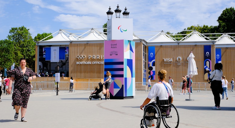 A wheelchair user, a member of the Paris Olympics staff, is walking past the official store located in front of the Grand Palais, in Paris, France on july 28, 2024. (Photo by Vincent Koebel/NurPhoto via Getty Images)
2163625334
inclusivity, city landmark, adaptive sports, cultural event, paris olympics, event staff, retail location, sports merchandise, public space, international event, athlete support, olympic games, official store, olympic staff, adaptive equipment, paris, nurphoto, urban environment, event planning, mobility, staff member, event photography, wheelchair user, vincent koebel, 2024 olympics
A wheelchair user, a member of the Paris Olympics staff, is walking past the official store located in front of the Grand Palais, in Paris, France on july 28, 2024.