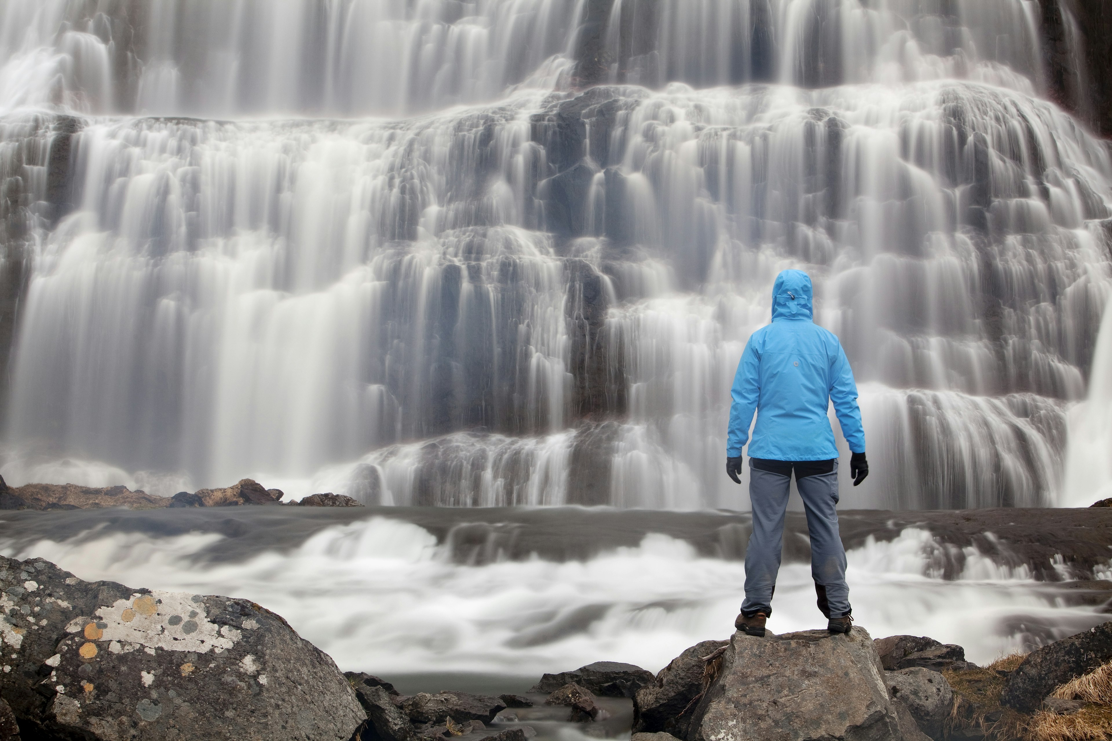 Hiker in front of the Dynjandi waterfall, Westfjords